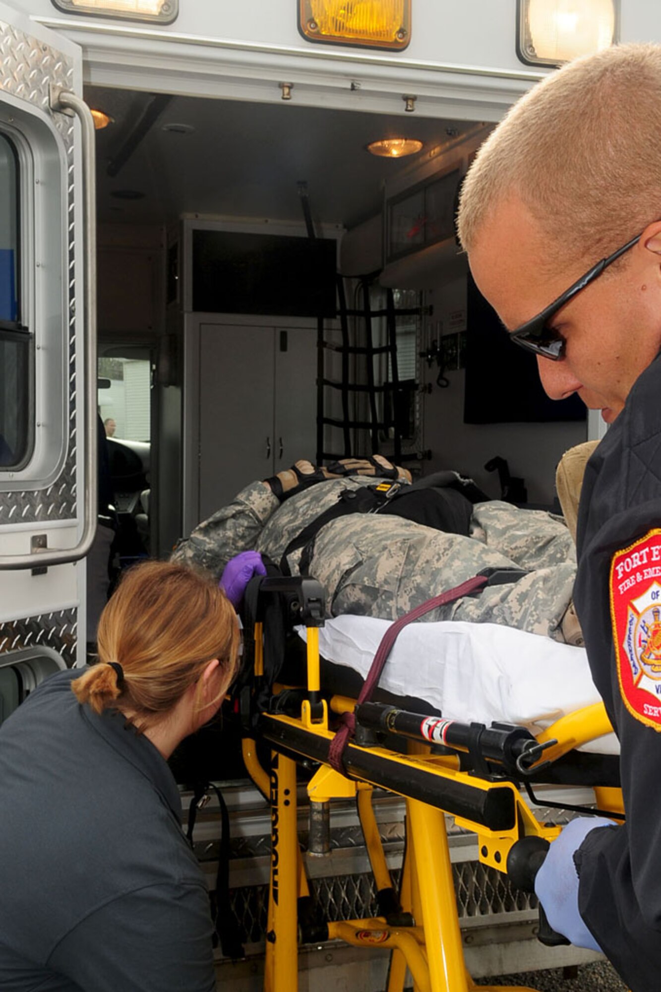 Fort Eustis paramedics help Spc. Justin Cox, a military police officer, into an ambulance during an active shooter exercise Dec. 6. (U.S. Air Force photo by Staff Sgt. Ashley Hawkins/Released)