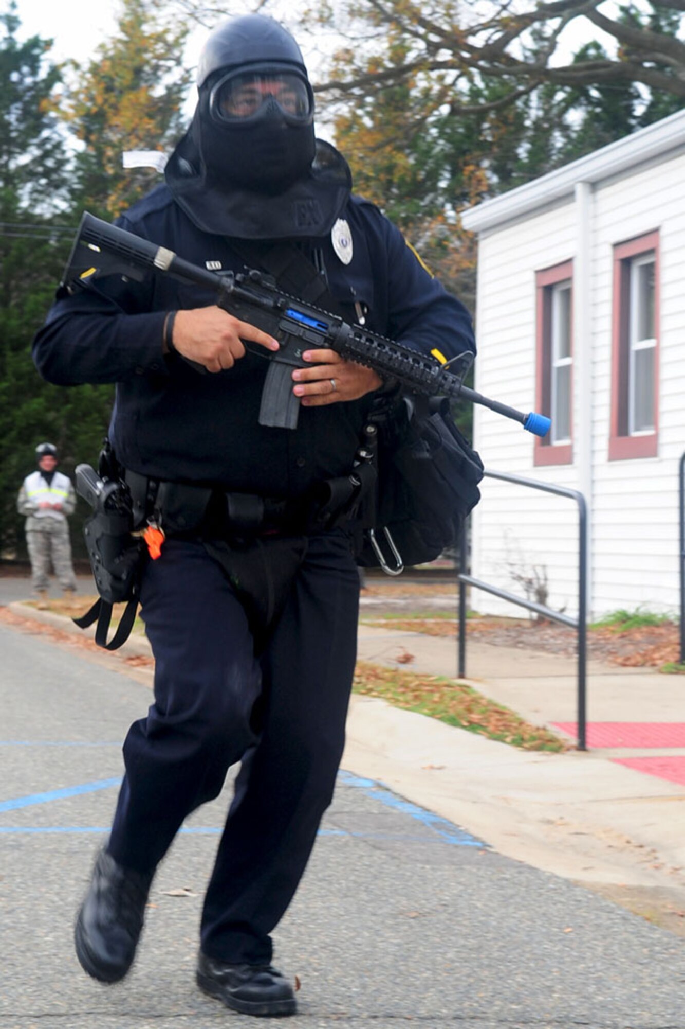 Officer Joe Gutierrez, field training officer, rushes to impede an attacker during an active shooter exercise at Fort Eustis Dec. 6. Members of the joint base’s military police department were tested on their response time and rescue capabilities in preparation for actual emergencies. (U.S. Air Force photo by Staff Sgt. Ashley Hawkins/Released)