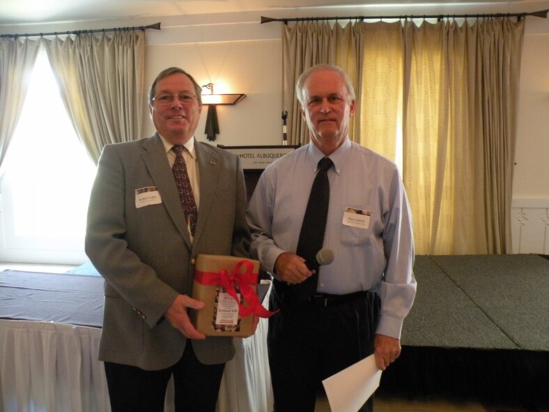 Robert Liddy, Equal Opportunity Office affirmative employment program manager, left, accepts an award on behalf of Kirtland Air Force Base from Paul Luttrell, Adelante Development Center associate vice-president for business development, in recognition of the base’s support of individuals with disabilities. U.S. Air Force Photo by Brian Brackens.