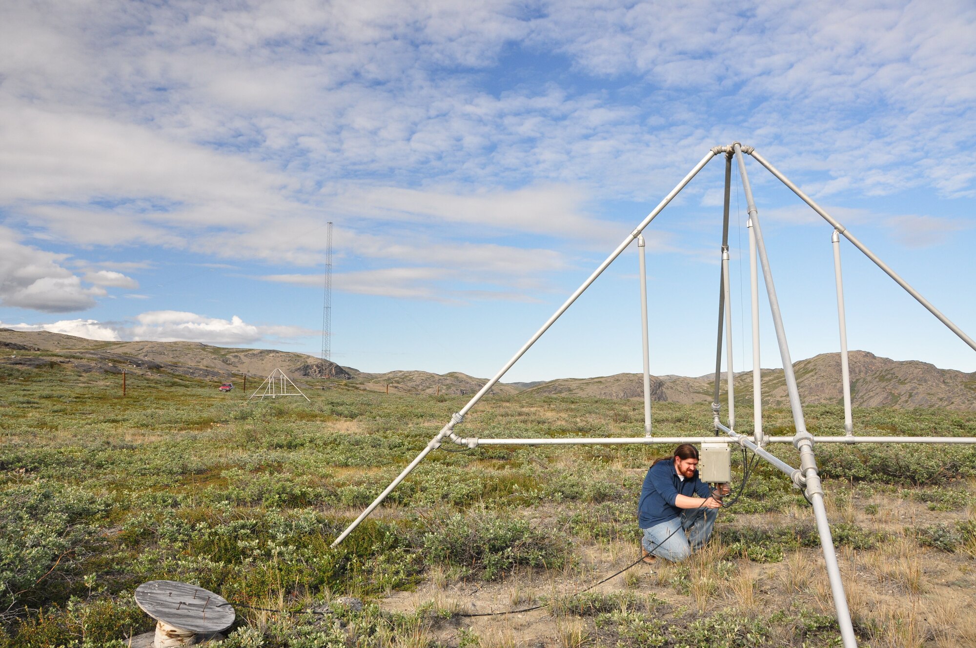 Battlespace Environment Division Research Electronics Engineer R. Todd Parris inspects ionosonde receive antenna in Kangerlussuaq, Greenland, in August. The Battlespace Environment Division’s Space Weather Center of Excellence maintains more than 30 ground stations around ground stations studying ionosphere located around the globe. The division is part of the Air Force Research Laboratory’s Space Vehicles Directorate.  Courtesy Photo..