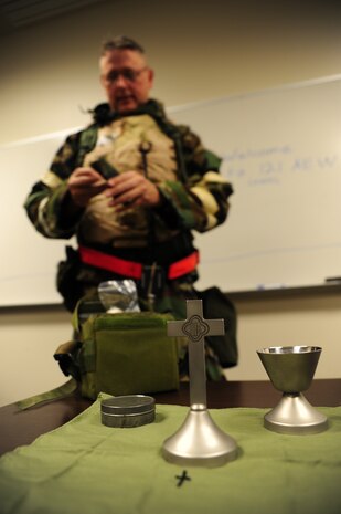 Capt. Leif Espeland prepares holy communion during the Operational Readiness Inspection at Gulfport, Miss. Dec. 4, 2011. More than 600 Airmen simulated a deployment for the ORI which tested Joint Base Charleston Airmen's readiness. Espeland is a chaplain with the 628th Air Base Wing chapel. (U.S. Air Force photo/Staff Sgt. Katie Gieratz)(Released)