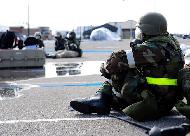Airmen from the 437th Operations Group respond to an evacuation order during the Operational Readiness Inspection at Gulfport, Miss. Dec. 3, 2011. The evacuation order was given in response to a simulated fire in their primary building. More than 600 Airmen simulated a deployment for the Operational Readiness Inspection that tested basic Airman knowledge, such as Self Aid Buddy Care and Chemical Biological Radioactive Nuclear and Explosive responses among many others. (U.S. Air Force photo/Staff Sgt. Katie Gieratz) (Released)