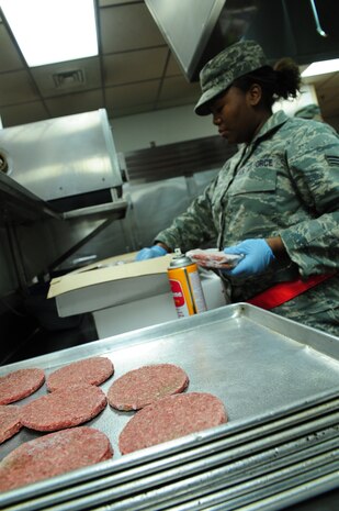 Senior Airman Andrea Turnley places frozen hamburger patties on a sheet to be cooked for the evening meal during the Operational Readiness Inspection at Gulfport, Miss. Dec. 1, 2011. Various scenarios the Airmen from Joint Base Charleston, S.C. endured during the ORI involved basic Airman knowledge, such as Self Aid Buddy Care and Chemical Biological Radioactive Nuclear and Explosive responses among many others. Turnely is a food services journeyman with the 628th Force Support Squadron. (U.S. Air Force photo/Staff Sgt. Katie Gieratz) (Released)