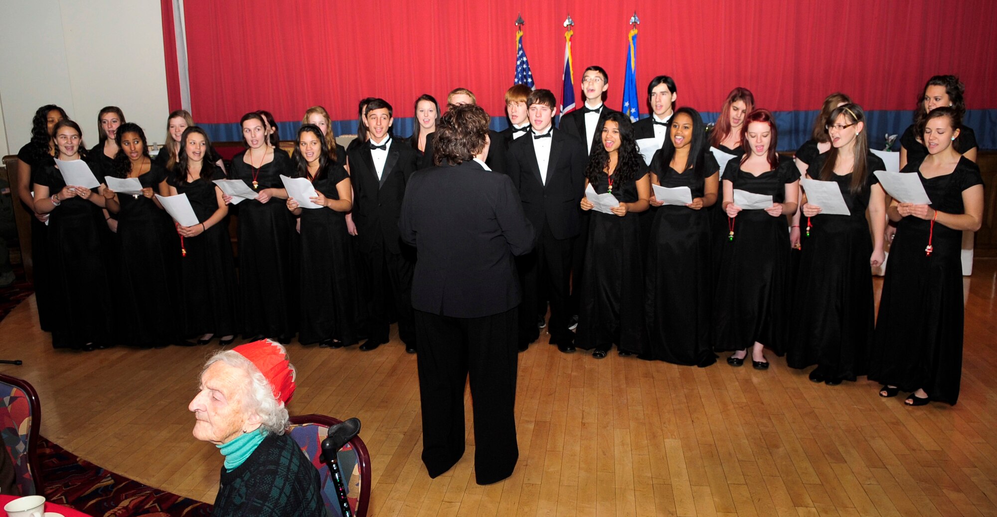 RAF MILDENHALL, England – The Lakenheath Chorale performs Christmas carols during the 30th Annual Senior Citizen Christmas Lunch here Dec. 7, 2011. The Lakenheath Chorale is comprised of members from the advanced choir class at RAF Lakenheath High School. (U.S. Air Force photo/Senior Airman Ethan Morgan)