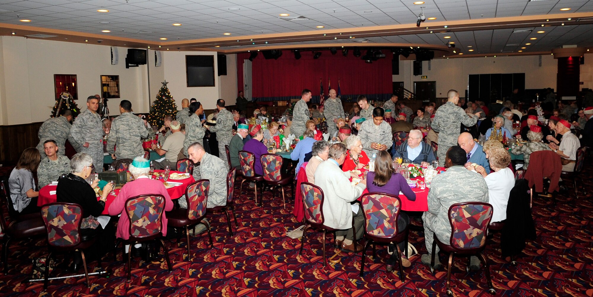 RAF MILDENHALL, England – Team Mildenhall members serve and dine with senior citizens from the local community at the 30th Annual Senior Citizen Christmas Lunch here Dec. 7, 2011. The lunch gave Airmen the opportunity to get to know the local community and show the guests hospitality. (U.S. Air Force photo/Senior Airman Ethan Morgan)