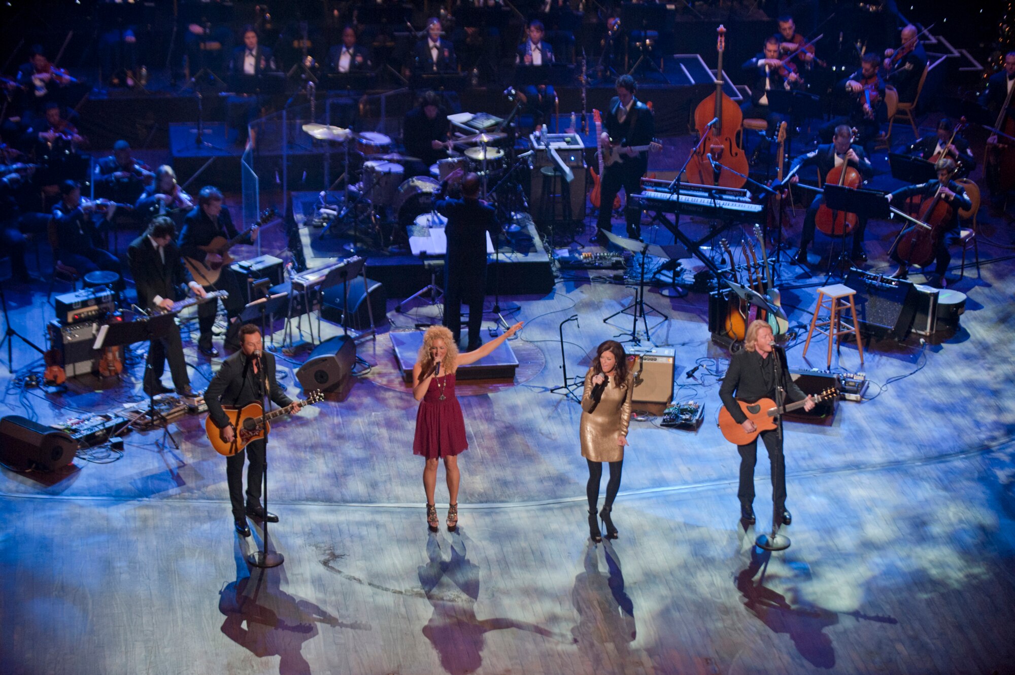 Little Big Town performs during the taping of "Holiday Notes from Home" at the Grand Ole Opry House, Nashville, Tenn. The group joined Lee Ann Womack, the Band of the U.S. Air Force Reserve and the Air Force Strings to record the hour-long special that will air on the American Forces Network and the Great American Country Network this holiday season. (U.S. Air Force photo/Ken Hackman)