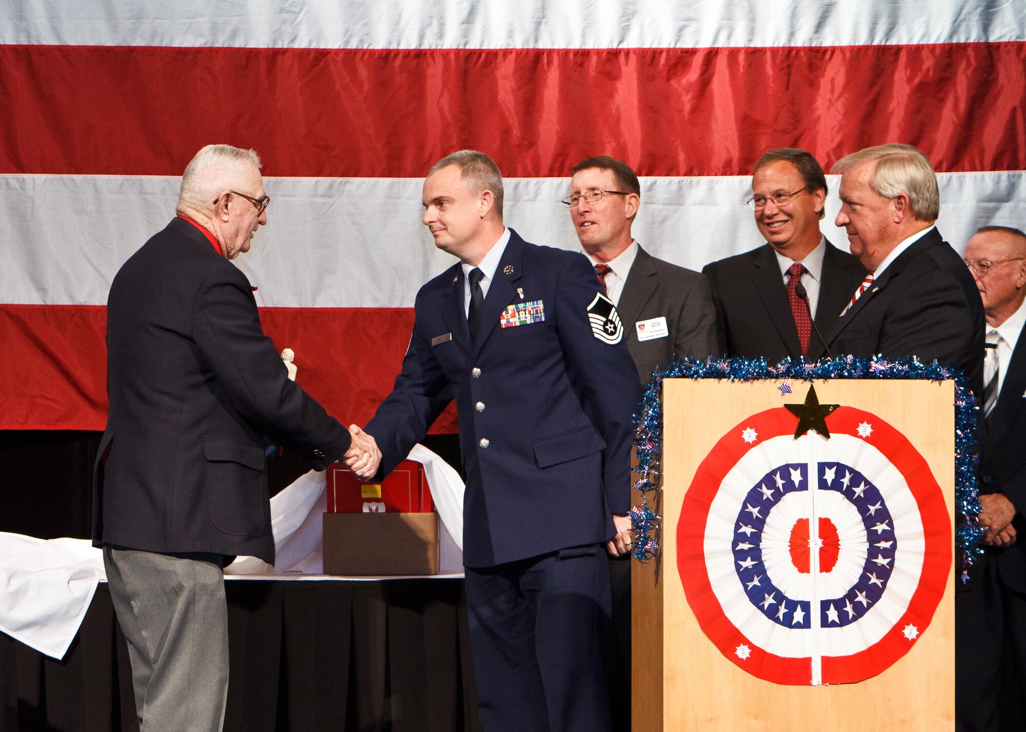 FORT WALTON BEACH, Fla. -- Master Sgt. William Ward, a 352nd Special Operations Group independent duty medical technician, (in uniform) receives the Air Commando Association Chief Master Sgt. Roland “Hap” Lutz Air Commando Medic of the Year award from Lutz himself. The award was presented Oct. 8, 2011, at the ACA’s Annual Reunion Banquet in recognition of Ward’s outstanding contributions to special operations medicine.  (Courtesy photo)