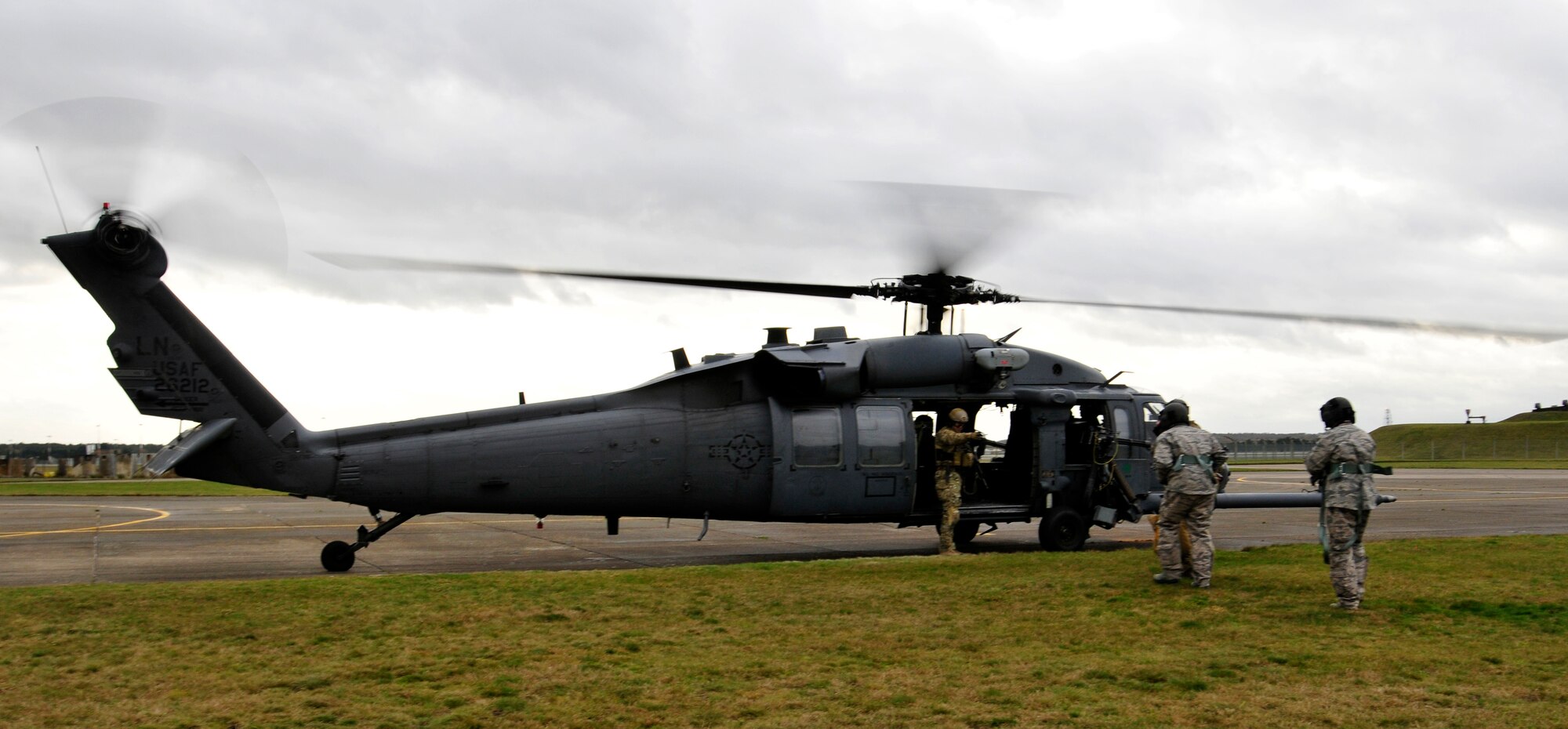 ROYAL AIR FORCE LAKENHEATH, England – Lord Edward Iveagh, the Right Honourable Earl of  Iveagh, Deputy Lieutenant and 56th Rescue Squadron honorary commander, Col. William Lewis, 48th Fighter Wing commander and others  proceed to an HH-60G Pave Hawk outside of the 56th RQS headquarters, Dec. 8, 2011. Iveagh visited the 56th RQS to receive a flight in a HH-60G Pave Hawk and familiarize himself with the 56th RQS mission. (U.S. Air Force photo by Senior Airman Tiffany M. Deuel)