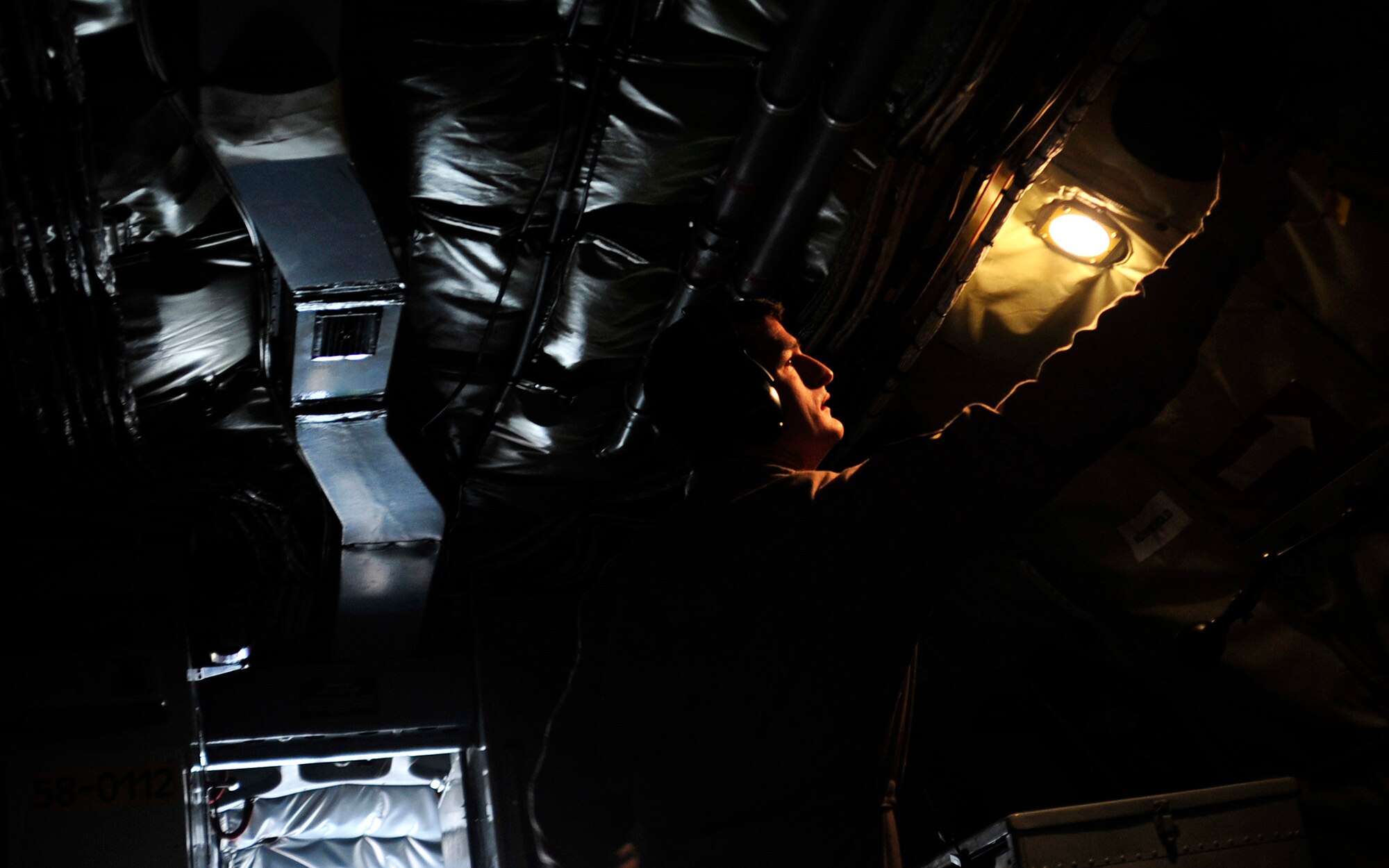 Tech. Sgt. Jason Vinson, 340th Expeditionary Air Refueling Squadron boom operator, conducts a pre-flight check on a KC-135 Stratotanker aircraft in an undisclosed location on Nov. 9, 2011. KC-135 Stratotankers with the 340th Expeditionary Air Refueling Squadron provided approximately 200,000 pounds of fuel each day to aerial assets in Iraq. (U.S. Air Force photo/Master Sgt. Cecilio Ricardo)