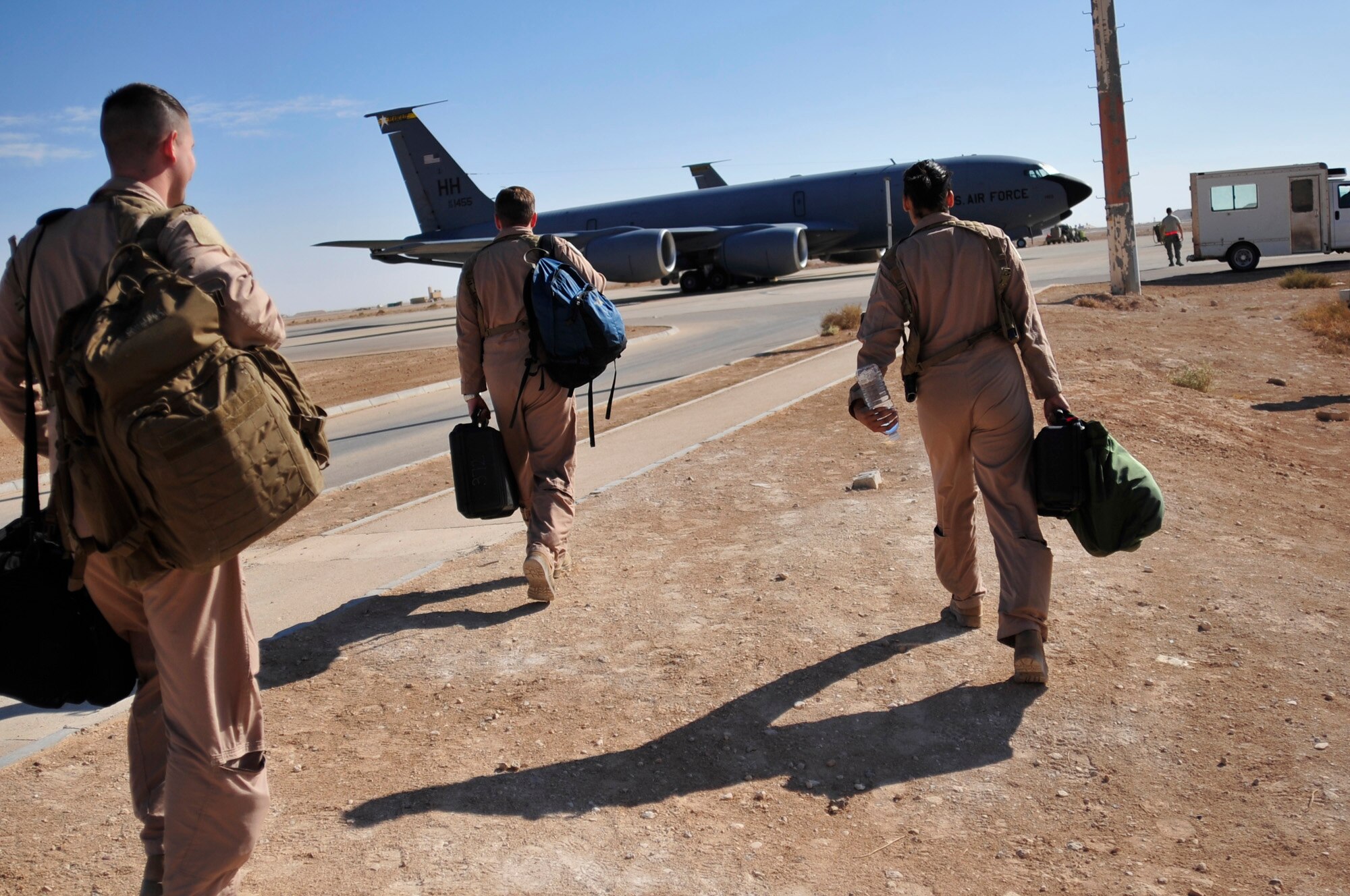 1st Lt. Ryan Chamberlin, left, 340th Expeditionary Air Refueling Squadron co-pilot, Capt. Justin Davis, middle, 340 EARS pilot, and Airman 1st Class Roslyn Longmire, right, 340 EARS boom operator, board a KC-135 Stratotanker refueling aircraft  prior to performing a refueling mission over Iraq Nov. 5, 2011. KC-135 Stratotankers provided approximately 200,000 pounds of fuel each day to aerial assets in Iraq. Davis is stationed at McConnell Air Force Base, Kan., and is from Roseburg, Ore. Chamberlin is stationed at McConnell AFB, Kan., and is from Hopkinton, N.H. Longmire is stationed at McConnell AFB, Kan., and is from Hampton Roads, Va. (U.S. Air Force photo/Master Sgt. Cecilio Ricardo)