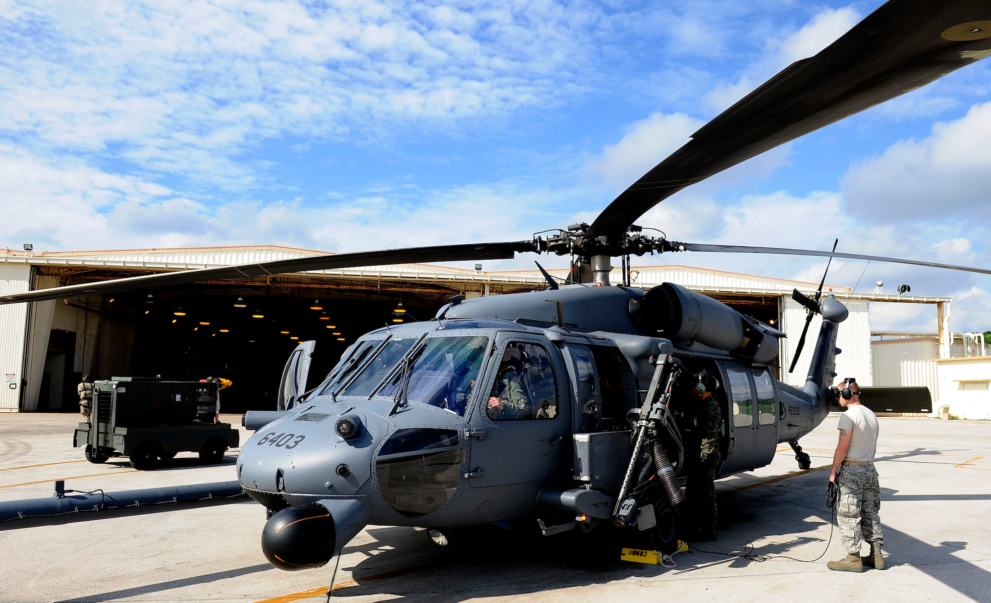 Members from the 33rd Rescue Squadron perform pre-flight checks on a U.S. Air Force HH-60G Pave Hawk helicopter before takeoff on Kadena Air Base, Japan, Dec. 7, 2011. This year marks the 12th year the U.S. Air Force on Okinawa has partnered up with JASDF for Cope Angel. (U.S. Air Force photo by Airman 1st Class Maeson L. Elleman/Released)