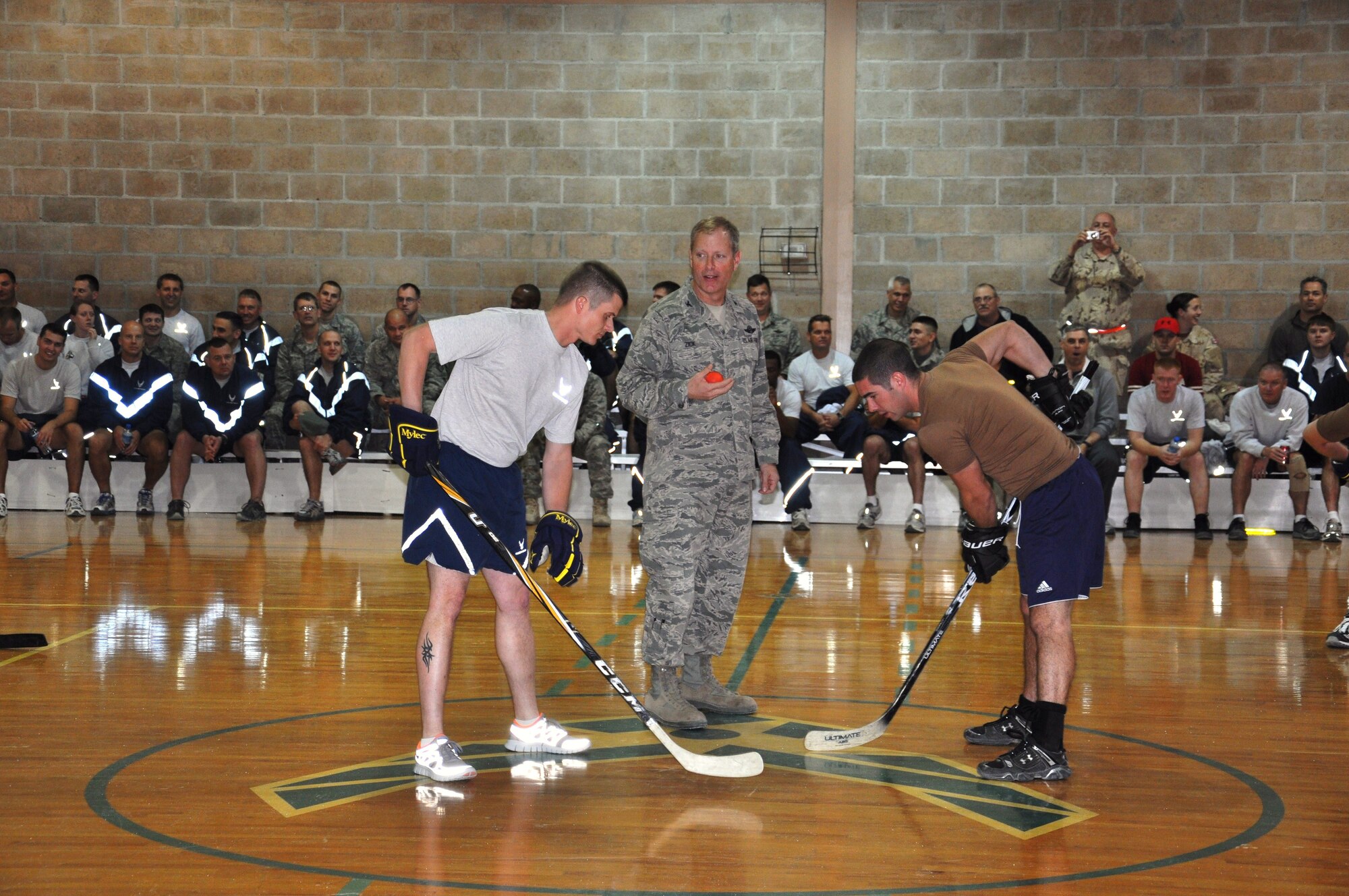 Col. Michael Zick, 386th Air Expeditionary Wing commander, commences the final floor hockey game Dec 2 at an undisclosed location in Southwest Asia. (U.S. Air Force photo by Senior Airman Rachelle Elsea)