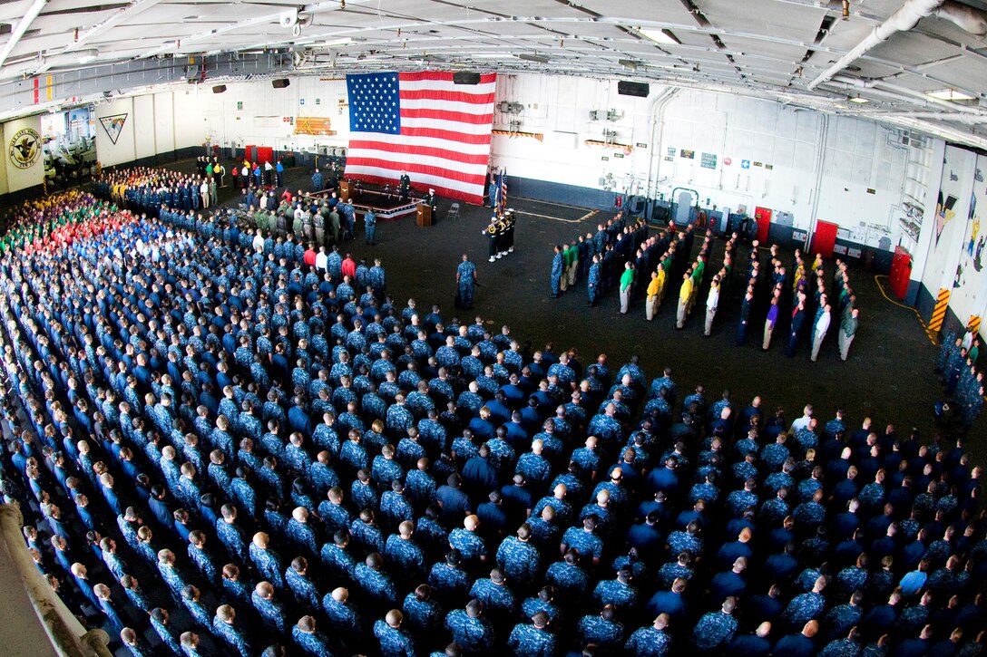 U.S. Navy sailors stand in ranks aboard the aircraft carrier USS Carl Vinson during a change-of-command ceremony in the ship's hangar bay while under way in the Pacific Ocean, Dec. 2, 2011. Capt. Bruce H. Lindsey was relieved by Capt. Kent D. Whalen as the ship's commanding officer during the ceremony. 