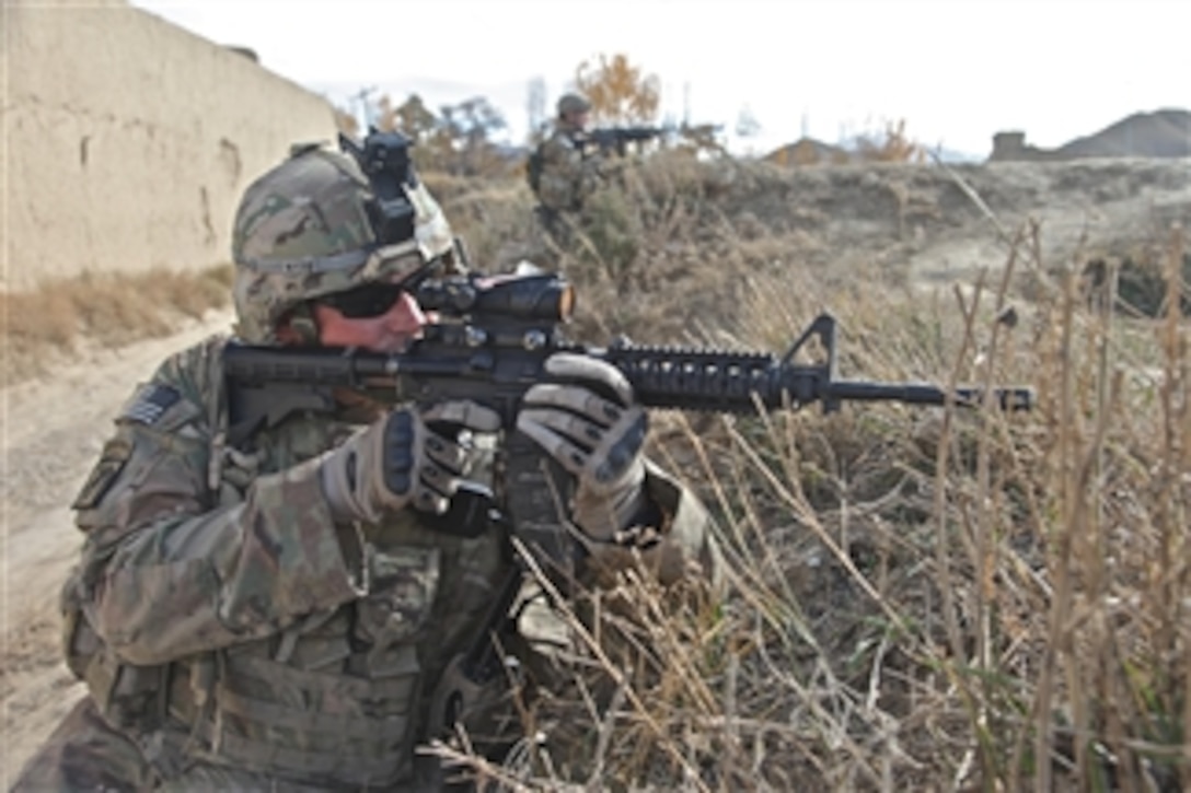 U.S. Army Staff Sgt. Greg Byce (left) and Spc. Sean Dobson, both assigned to Security force Platoon, provide security along an embankment at Khoshi Valley, Logar province, Afghanistan, on Nov. 17, 2011.  