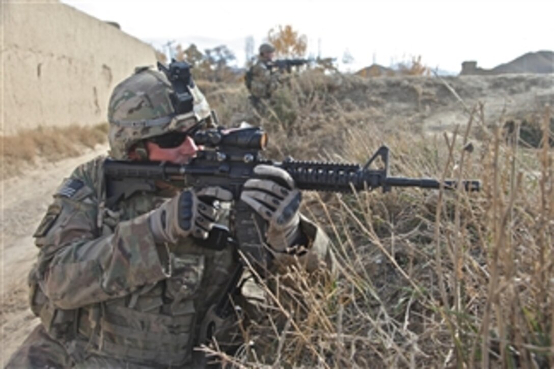 U.S. Army Staff Sgt. Greg Byce (left) and Spc. Sean Dobson, both assigned to Security force Platoon, provide security along an embankment at Khoshi Valley, Logar province, Afghanistan, on Nov. 17, 2011.  