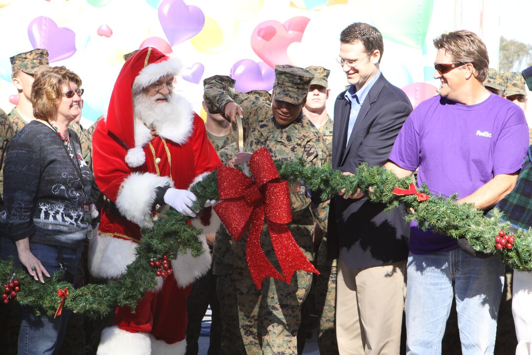 Two Marines from Marine Corps Logistics Base Barstow select Christmas trees during the annual Trees for Troops event at Desert View Housing Office aboard MCLB Barstow, Dec. 9.
