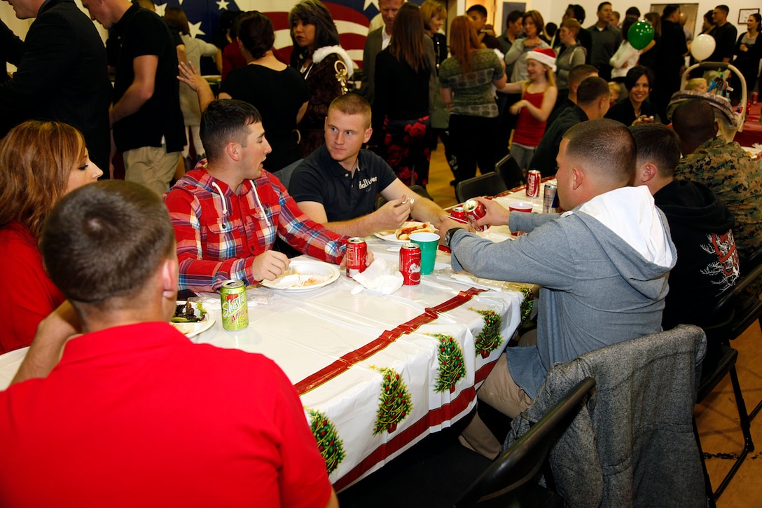 15th Marine Expeditionary Unit Command Element Marines enjoy a meal at the holiday party hosted at the Abby Reinke Community Center on base, Dec. 9. The event also gave the unit’s leadership the opportunity to welcome the unit’s new Family Readiness Officer, Rebecca Roman and bid farewell to Audrey Hooper, who served as the unit’s FRO on the last deployment. During the holiday party the families enjoyed good food and company while Santa Claus passed out gifts and took photos with kids. (U.S. Marine Corps photo by Cpl. John Robbart III)