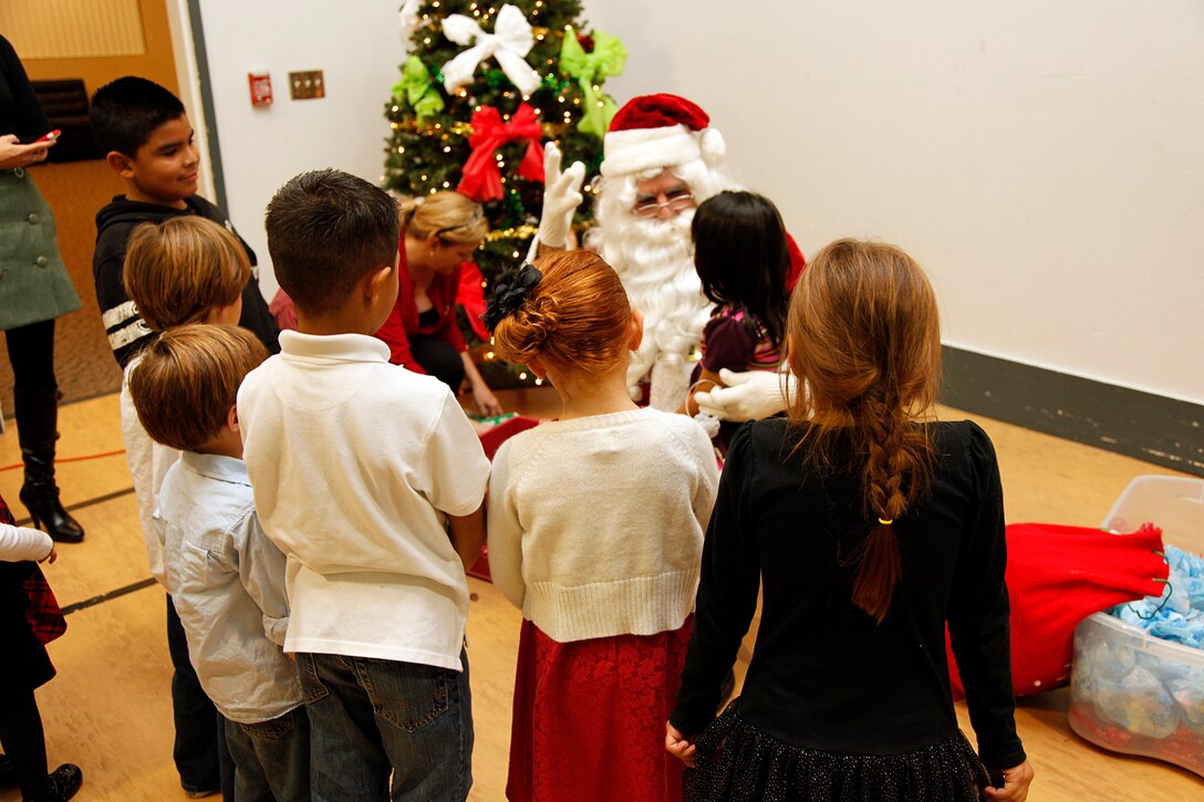 Santa Claus was available for the children of the 15th Marine Expeditionary Unit at the holiday party hosted at the Abby Reinke Community Center on base, Dec. 9. The event also gave the unit’s leadership the opportunity to welcome the unit’s new Family Readiness Officer, Rebecca Roman and bid farewell to Audrey Hooper, who served as the unit’s FRO on the last deployment. During the holiday party the families enjoyed good food and company while Santa Claus passed out gifts and took photos with kids. (U.S. Marine Corps photo by Cpl. John Robbart III)
