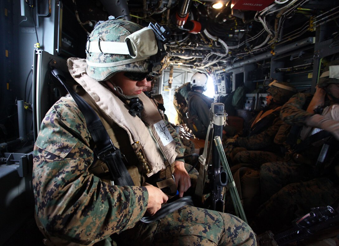 Lance Cpl. Mitchell Montgomery, a radio operator with Bravo Company, Battalion Landing Team 1st Battalion, 2nd Marine Regiment, 24th Marine Expeditionary Unit, buckles his seat belt aboard an MV-22 Osprey during extract from a simulated humanitarian assistance operation here Dec. 9, 2011. Supporting humanitarian assistance and disaster relief missions is a task that MEUs train for during their six-month work up period to prepare for deployment. The 24th MEU is currently taking part in Composite Training Unit Exercise (COMPTUEX), scheduled to take place Nov. 28 to Dec. 21. The training is meant to develop cohesion between the 24th MEU and Amphibious Squadron 8 (PHIBRON 8) in conducting amphibious operations, crisis response, and limited contingency operations while operating from the sea.