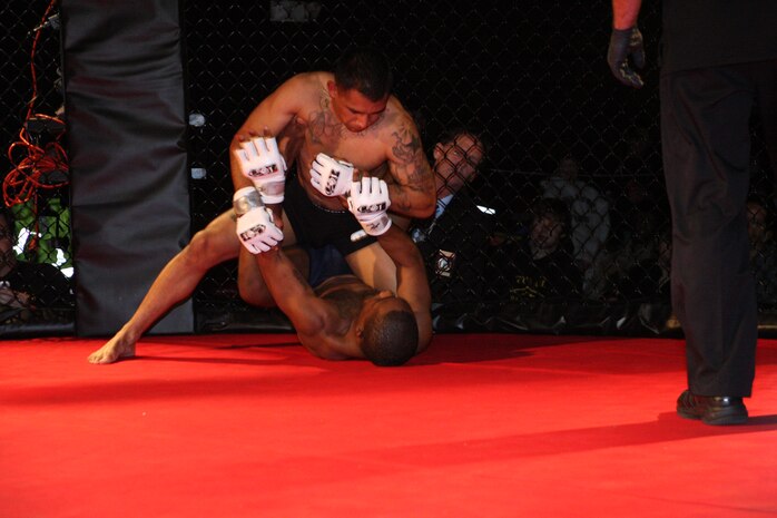 Sgt. Ryan Galvan, a Marine combat instructor with Infantry Training Battalion, School of Infantry-East ties to move to a full mount in his fight with Cleveland Mclean during Richard Dambakly’s Battle in the South 2 amateur mixed martial arts championship. The championship took place at Hooligan Rub and Music Hall in Jacksonville, Saturday.