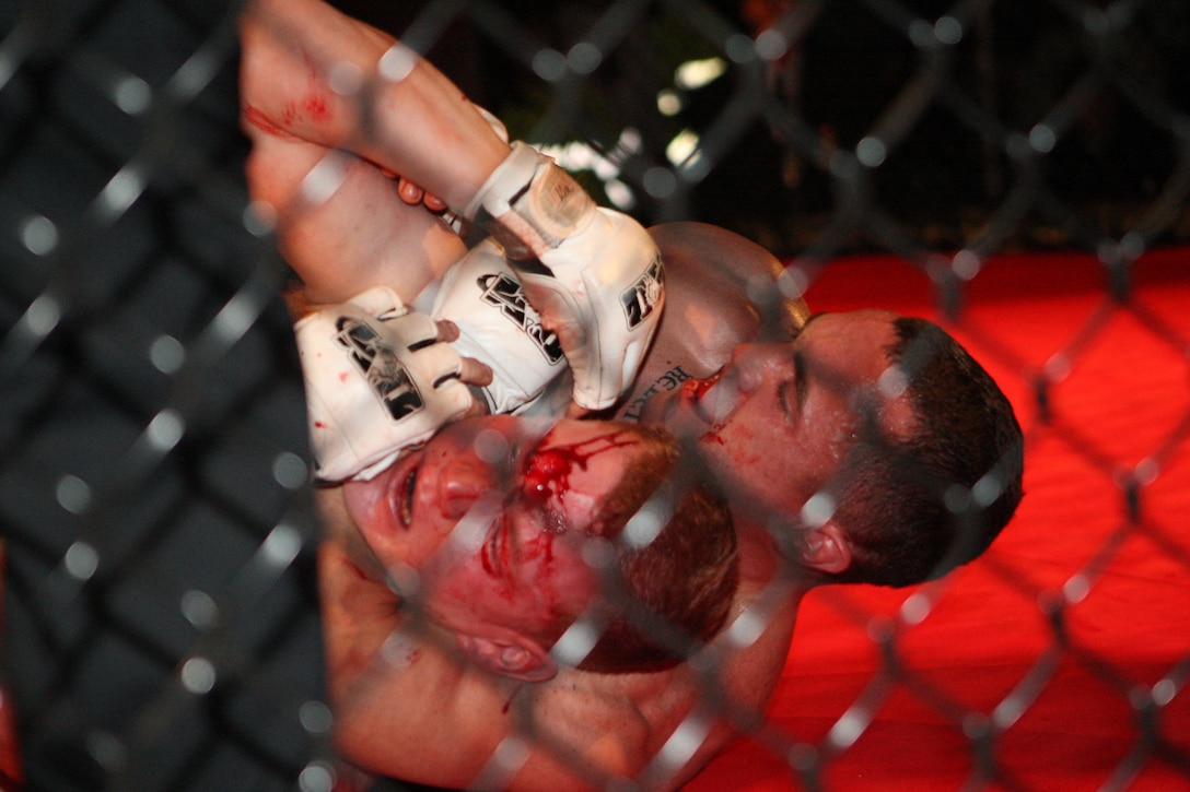 James Markham gets Cpl. Matt Berg, a field wireman with Headquarters Company, 2nd Marine Regiment, 2nd Marine Division in a rear-naked-choke during Richard Dambakly’s Battle in the South 2 amateur mixed martial arts championship. The event featured eight bouts, four of which featured five Marines from Marine Corps Base Camp Lejeune.