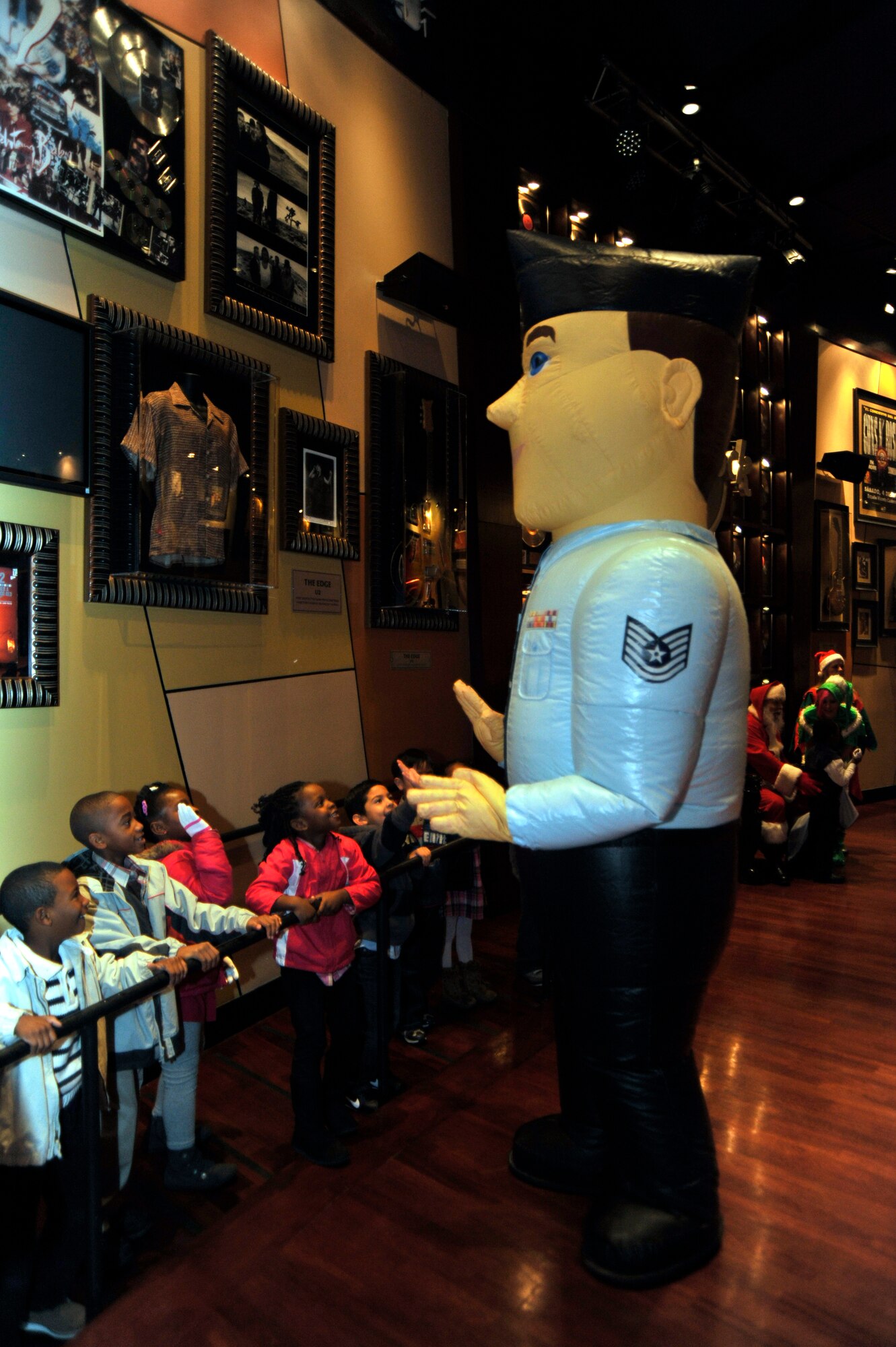 The 403rd Wing Recruiting Squadron teamed with Santa Claus to bring a morning of Christmas cheer to the Boys and Girls Club of Biloxi at the Hard Rock Cafe Dec. 10. Airman Andy entertained the children while they waited in line to tell their Christmas wish to Santa. (U.S. Air Force photo by Maj. Heather Newcomb)