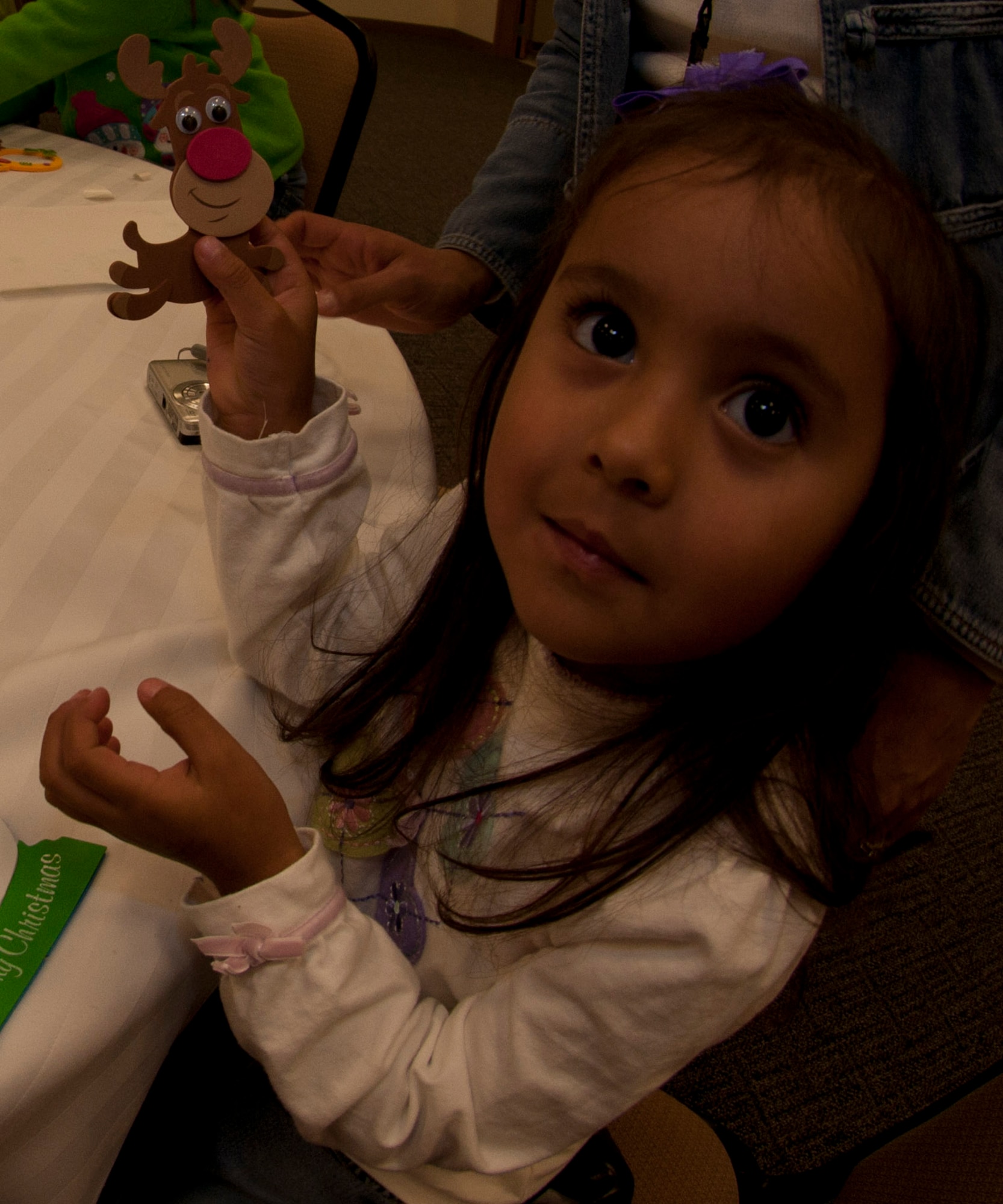 Emily, three, daughter of 403rd Maintenance Squadron maintainer, Marina Martinez, shows off the reindeer ornament she made during the 403rd Wing's Childrens' Christmas Party Dec. 10. (U.S. Air Force photo by Capt. J. Justin Pearce)