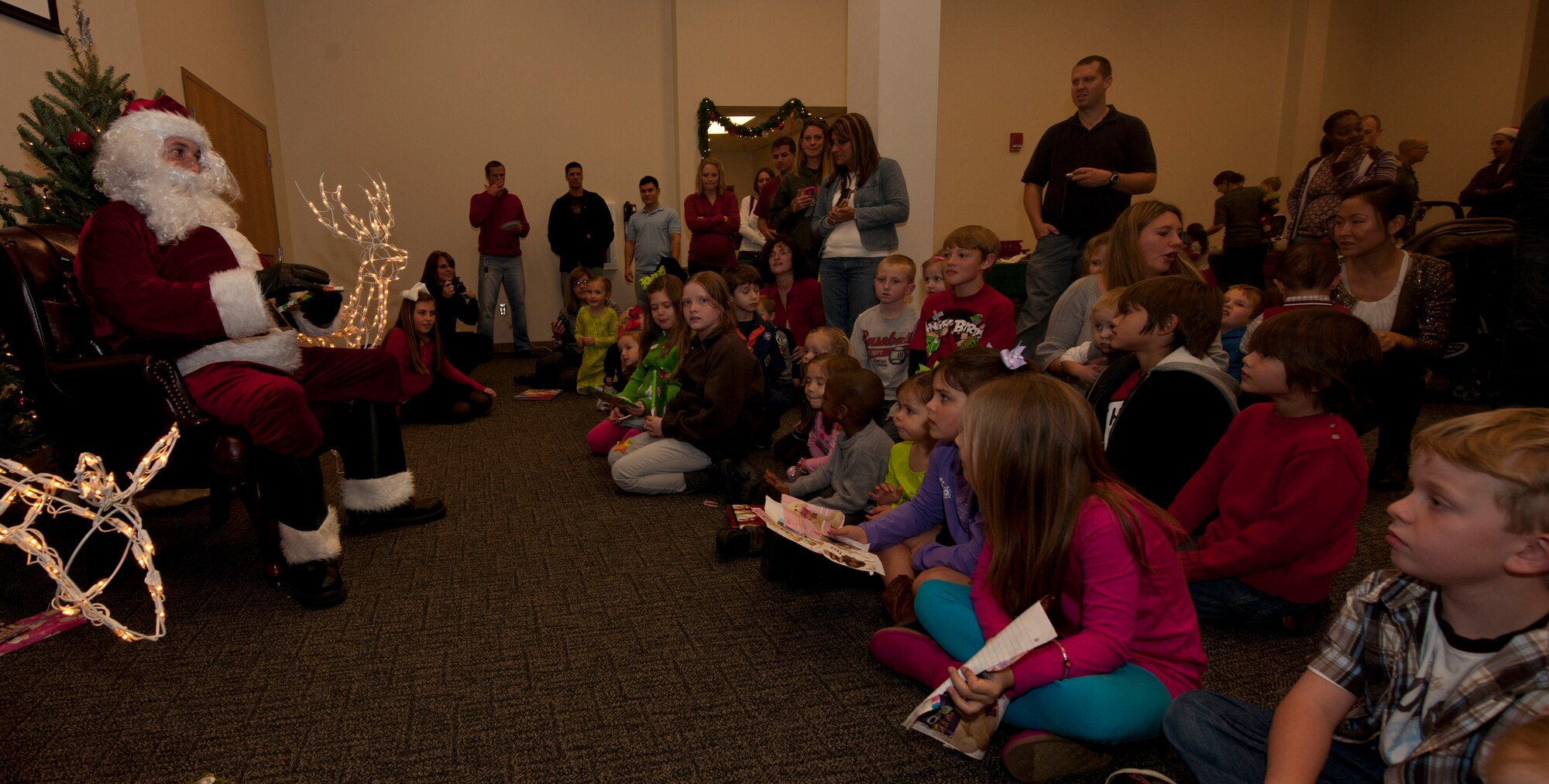 Santa Claus spends time with the children of the 403rd Wing, handing out early Christmas presents and listening to their wishes for Christmas Day. Santa arrived from the North Pole aboard one of the Wing's C-130Js.