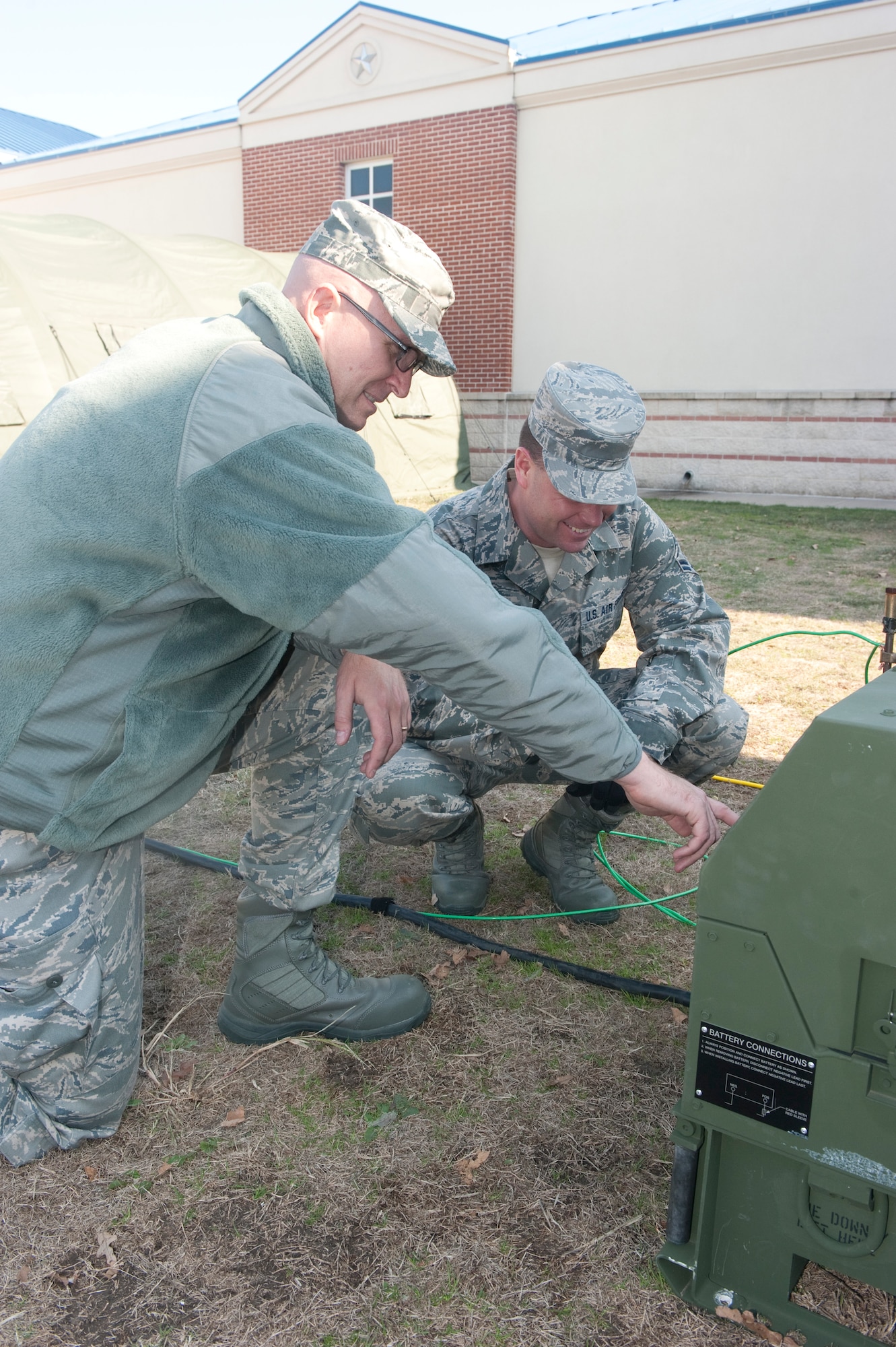 Air Force Senior Airman Shawn Mckibben and Airman1st Class Gary Bromley, 136th Airlift Wing Civil Engineers Squadron, Texas Air National Guard, train on the generator operation and set up, Dec. 10, 2011. Mckibben and Bromley are tasked with supplying electrical power to newly constructed tents for an upcoming Operational Readiness Exercise held early next year. (Air National Guard photo by Tech. Sgt. Charles Hatton)