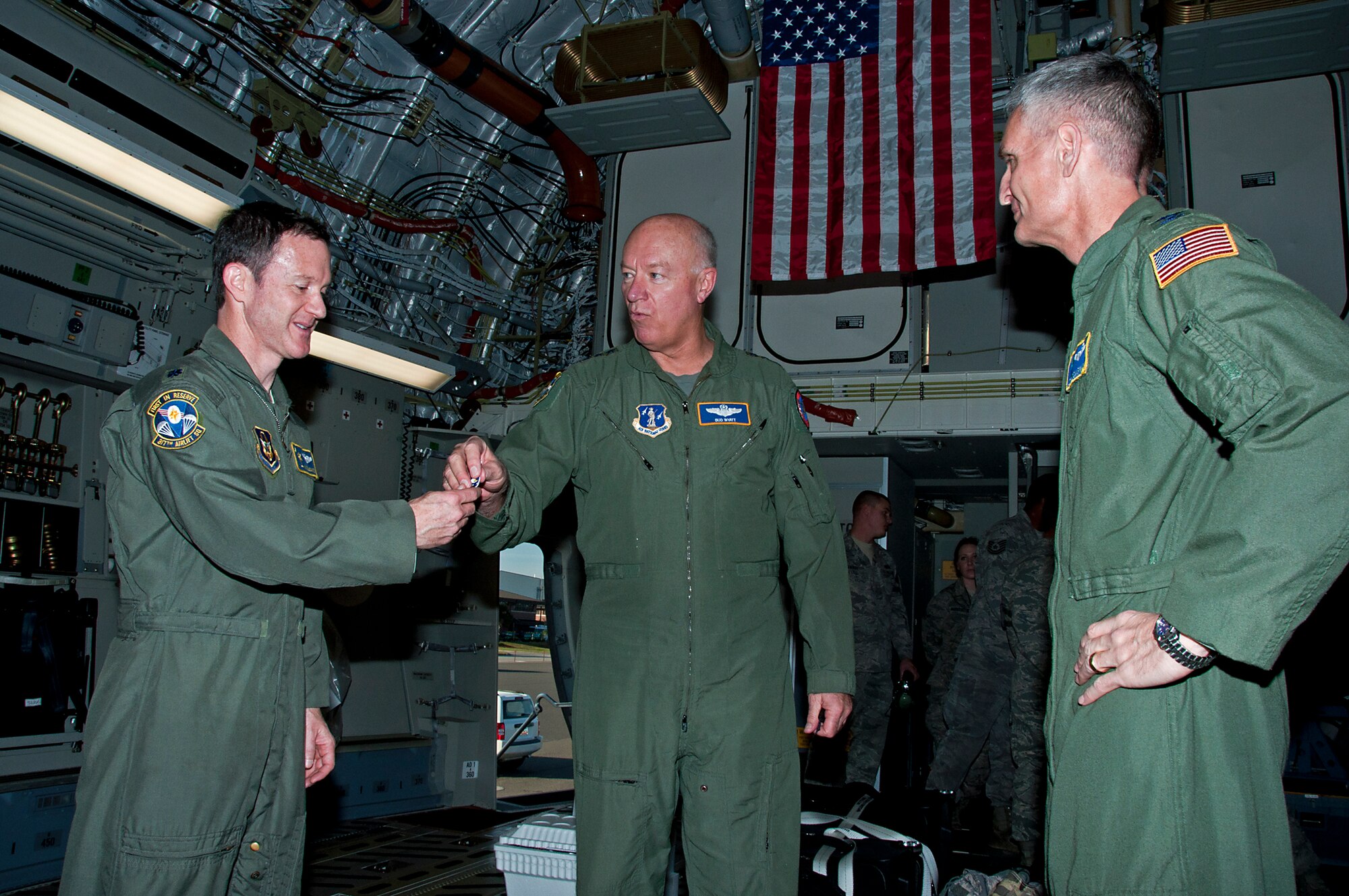 Lt. Gen. Harry M. Wyatt III, Air National Guard director, passes the symbolic "keys" to Joint Base Charleston's newest C-17 to Lt. Col. Mike DeSantis, 317th Ailift Squadron, so that he can present them to 315th Airlift Wing Commander, Col. Steven Chapman. The general was the honorary aircraft commander during the flight from Longbeach, Calif. while Colonel DeSantis was one of the pilots.
 (U.S. Air Force Photo by Michael Dukes)
