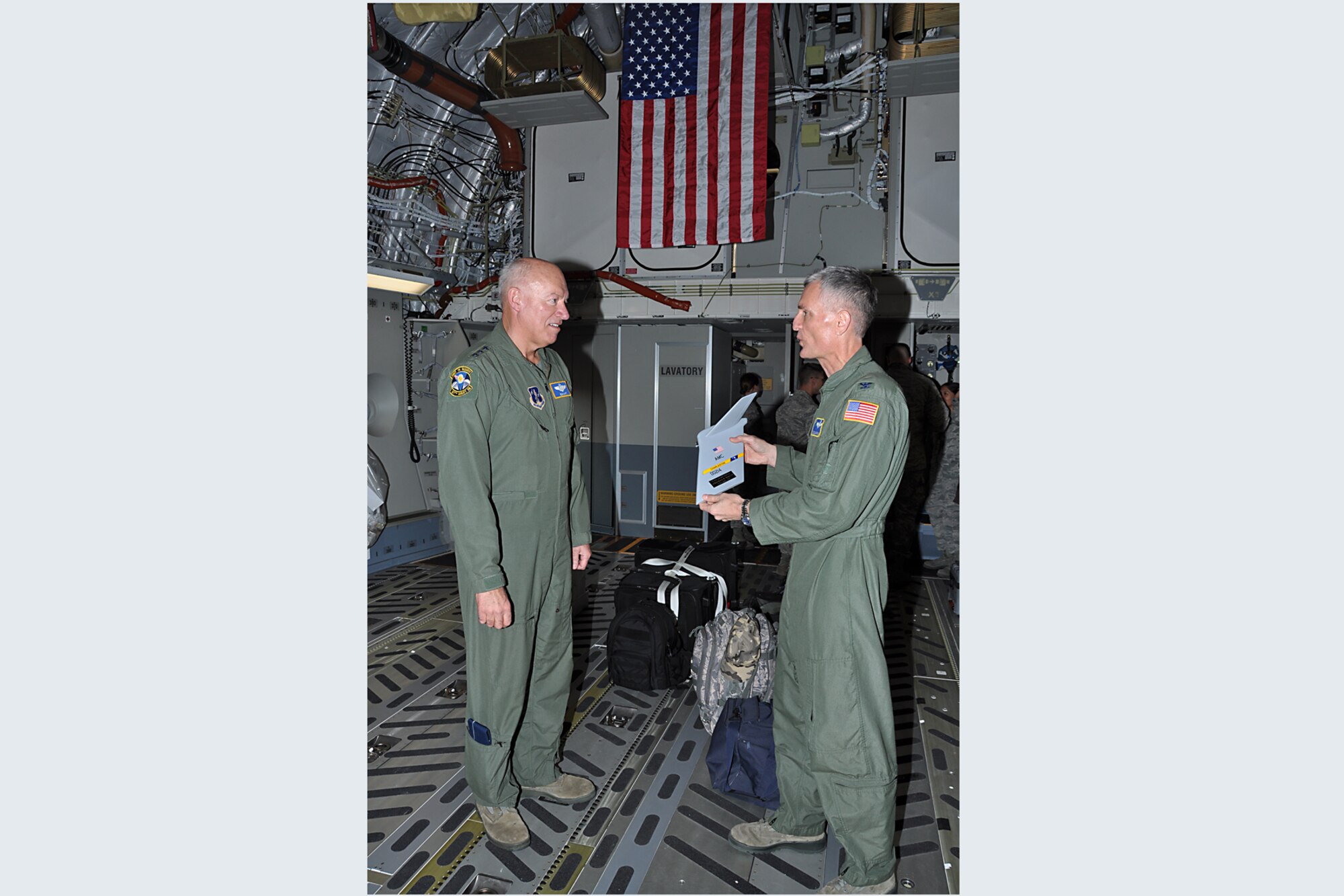 Col. Steven Chapman, 315th Airlift Wing commander, presents a commemorative T-tail to Lt. Gen. Harry M. Wyatt III, Air National Guard director, after the general flew with a crew from the 315th Airlift Wing in Joint Base Charleston's newest C-17 which arrived Dec. 9, 2011. (U.S. Air Force Photo by Michael Dukes)