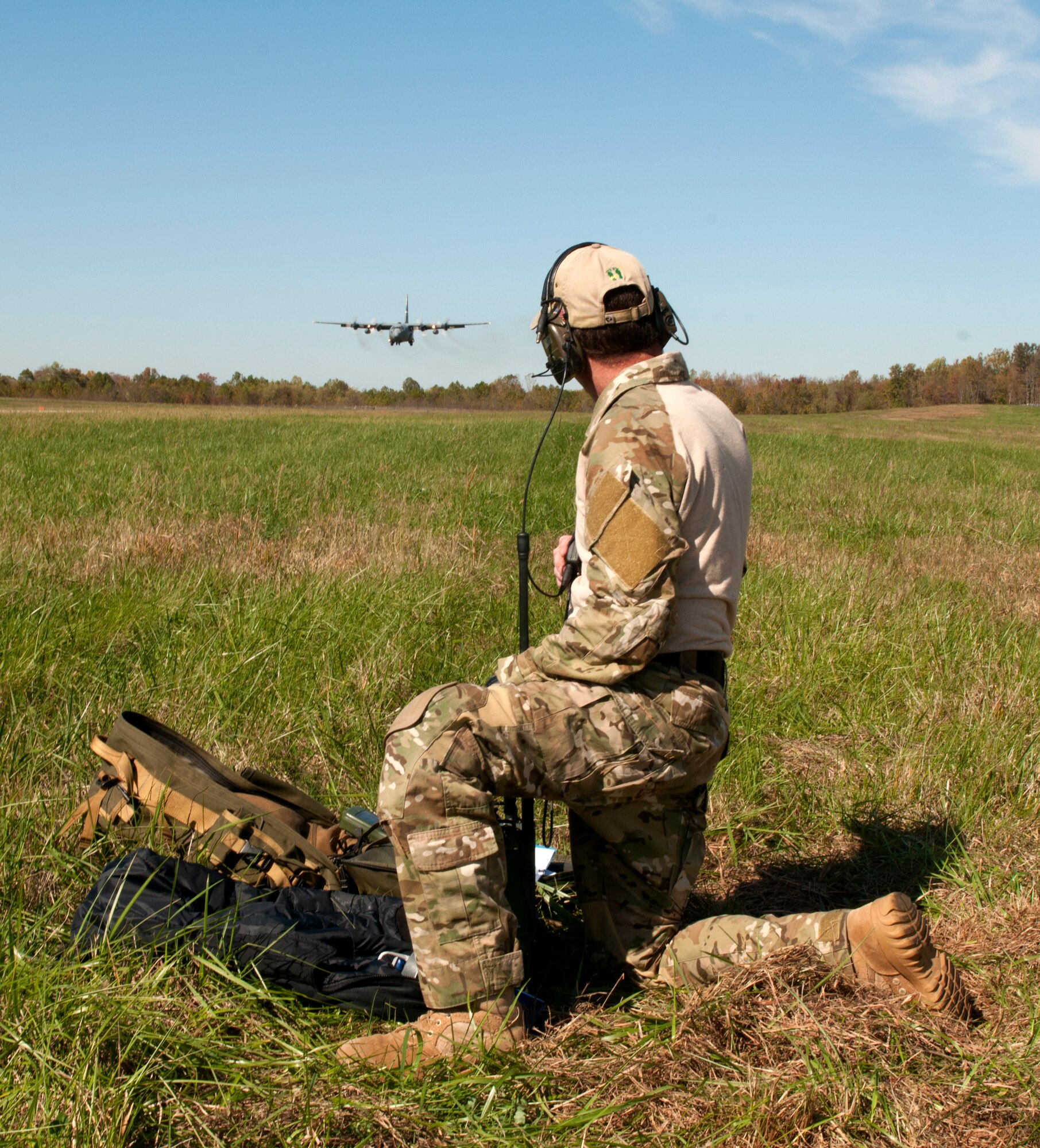 A Kentucky Air National Guard combat controller observes as one of the unit's C-130s approaches the runway at Fort Knox, Ky., during the first-annual Air Derby, held Oct. 22, 2011. The contest scored aircrews in multiple areas, including threat and airspace avoidance, airdrop accuracy and assault landing accuracy. (U.S. Air Force photo by Master Sgt. Phil Speck)