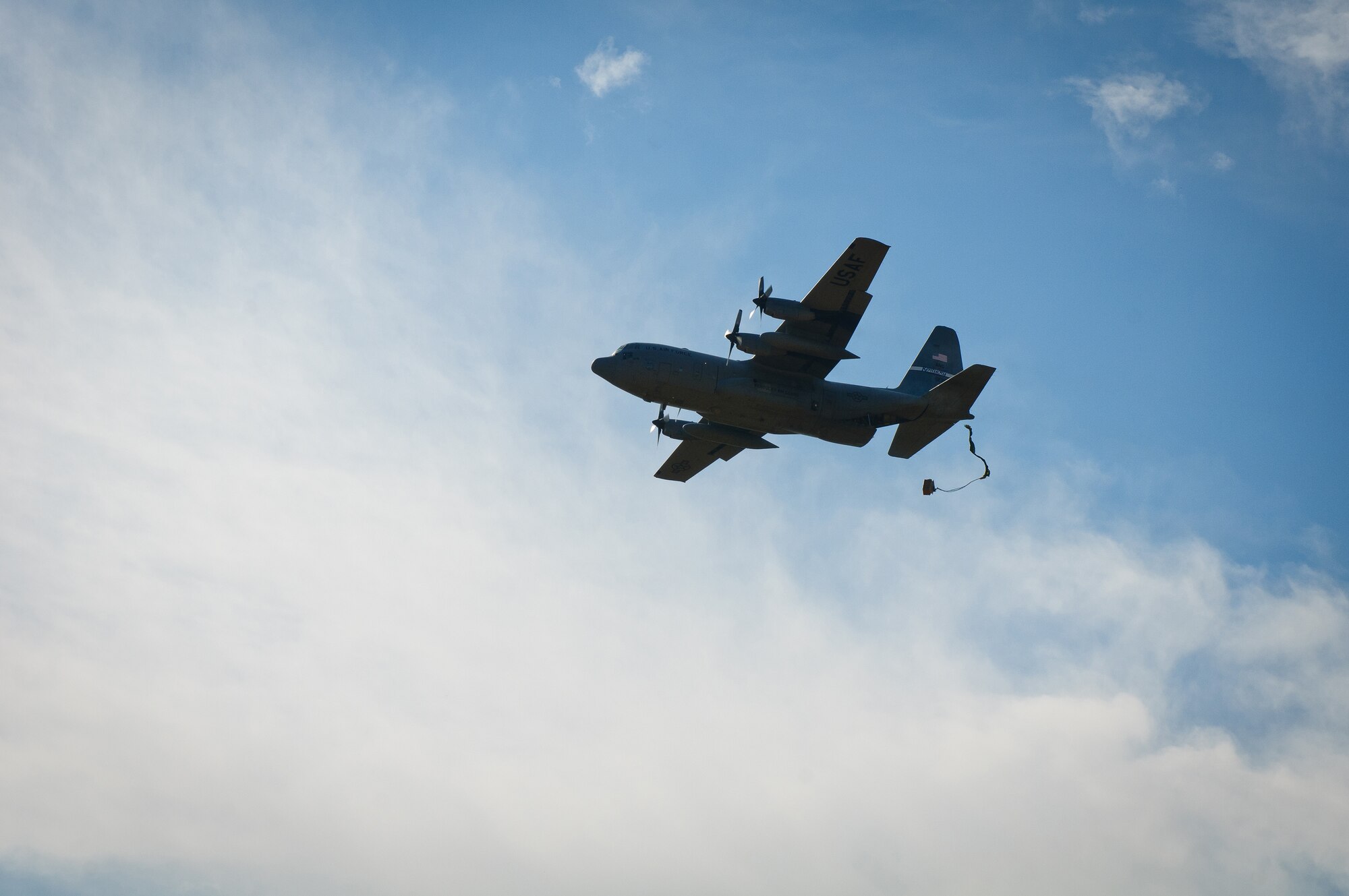A C-130, piloted by aircrew members of the Kentucky Air National Guard's 165th Airlift Squadron, deploys cargo over a drop zone at Fort Knox, Ky., during the unit's first-annual Air Derby competition Oct. 22, 2011. The contest scored crews in multiple areas, including threat and airspace avoidance, airdrop accuracy and assault landing accuracy. (U.S. Air Force photo by Senior Airman Maxwell Rechel)