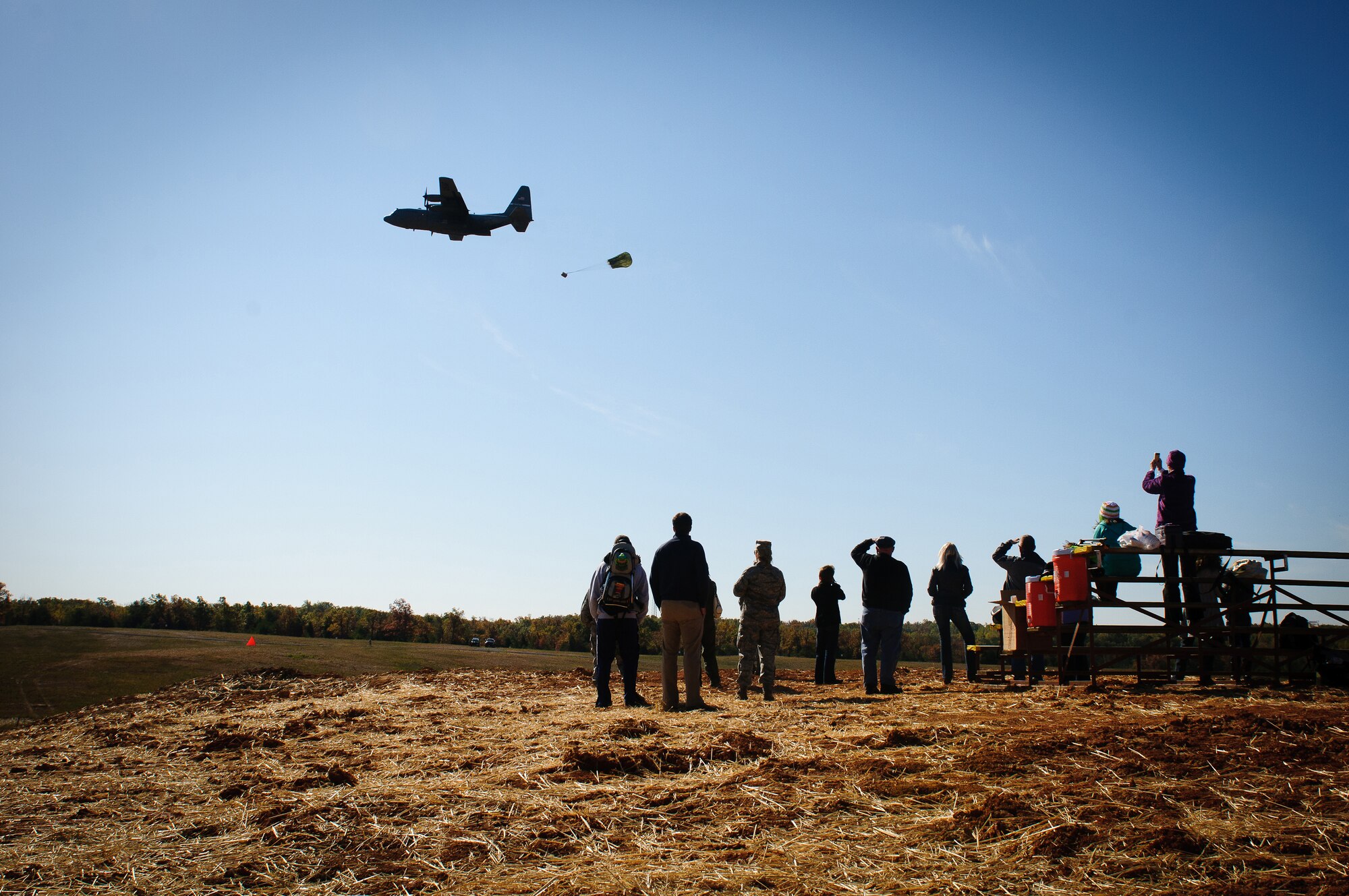 A C-130, piloted by aircrew members of the Kentucky Air National Guard's 165th Airlift Squadron, deploys cargo over a drop zone at Fort Knox, Ky., during the unit's first-annual Air Derby competition Oct. 22, 2011. Family members of the Airmen were in attendance to witness the friendly competition. (U.S. Air Force photo by Senior Airman Maxwell Rechel)