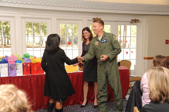 U.S. Air Force Col. Patrick Doherty and his wife Dee Dee greet 4th Fighter Wing spouses during a Heart Link event at Seymour Johnson Air Force Base, N.C., Nov 2, 2011. Heart Link is open to any spouse and provides those new to the base an overview of the wing mission, various organizations, and the importance of readiness. Doherty is the 4th FW commander and is a native of Bellevue, Neb. (U.S. Air Force photo by Senior Airman Whitney Stanfield/Released) 
