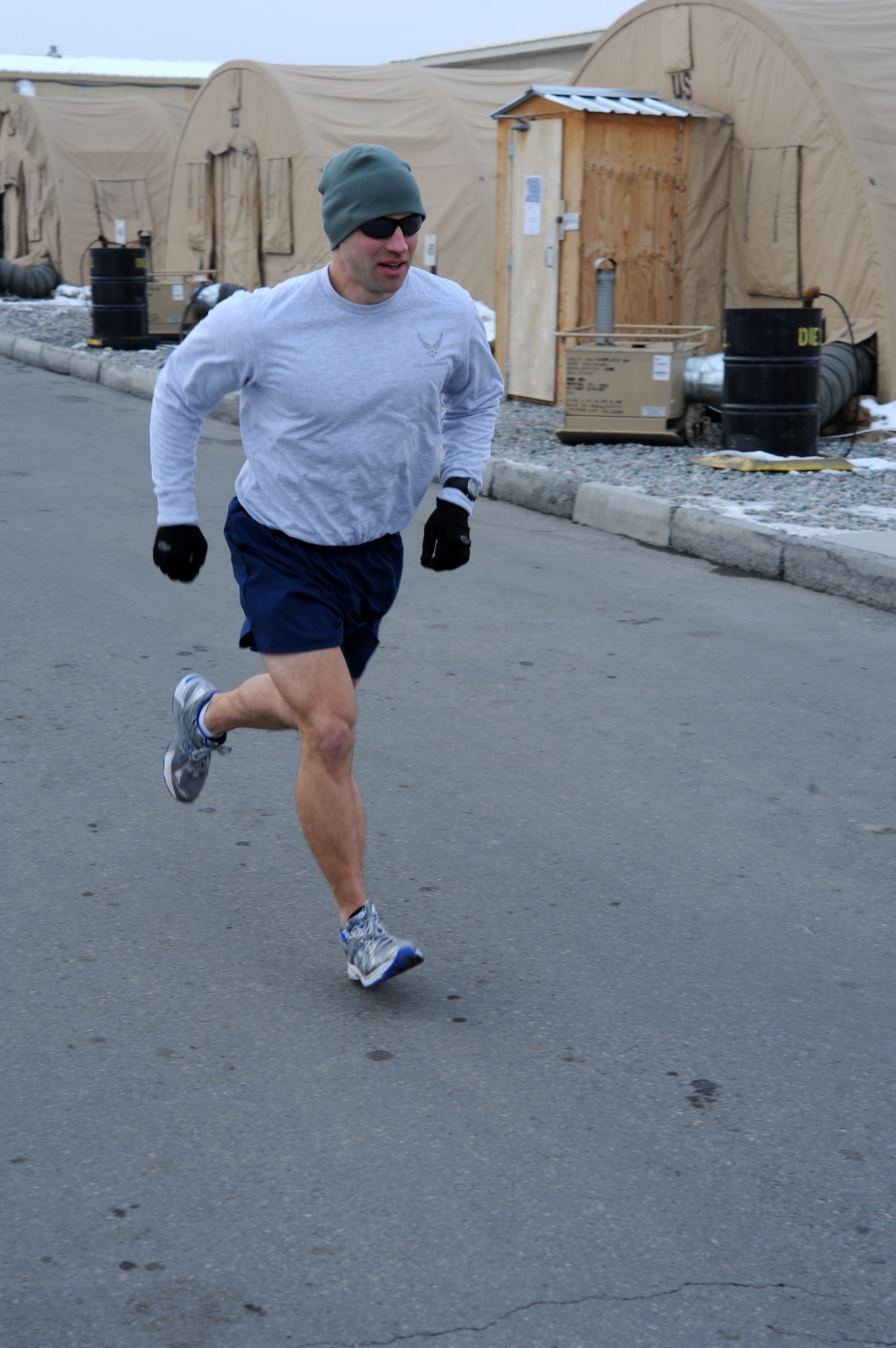 Capt. Ross Dotzlaf runs his final 5K race at the Transit Center at Manas, Kyrgyzstan, Dec. 10, 2011. Dotzlaf, the 376th Expeditionary Civil Engineer Squadron Programs Flight chief, set a goal to run 1,000 miles during his six-month deployment, but ended up running 1,111 miles at a 6-minute mile average. Dotzlaf is deployed from Peterson Air Force Base, Colo. (U.S. Air Force photo/Tech. Sgt. Hank Hoegen)