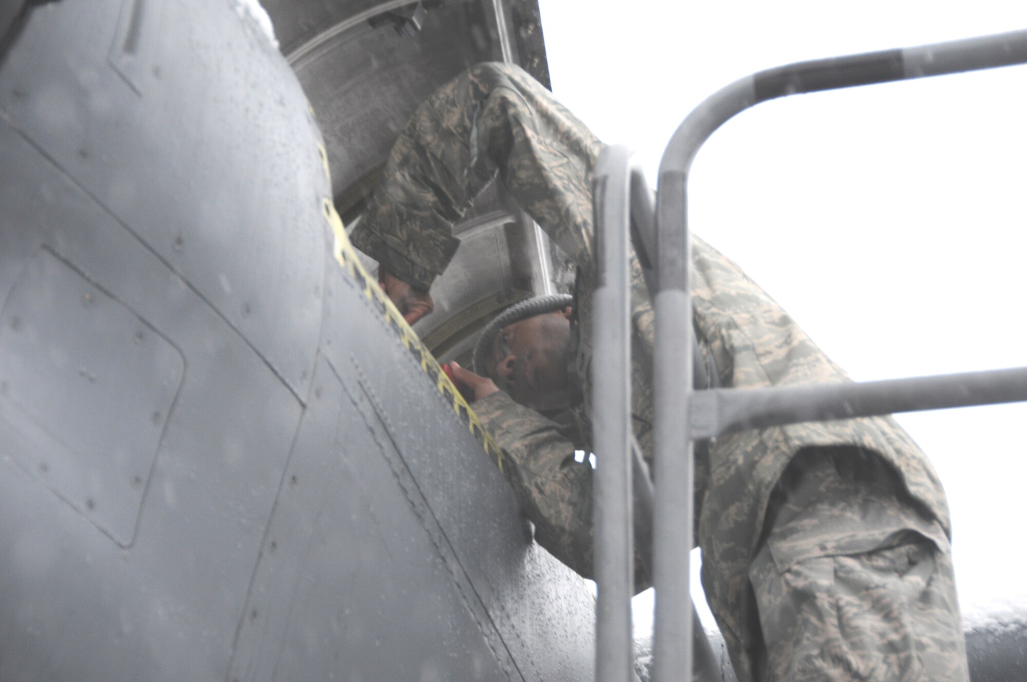 Senior Airman Rosen Rose from the 914th Airlift Wing electric shop does some final inspections on the C-130 at the Niagara Falls Reserve Station while the lake effect storms hits the area.(Air Force Photo/SMSgt Ray Lloyd)