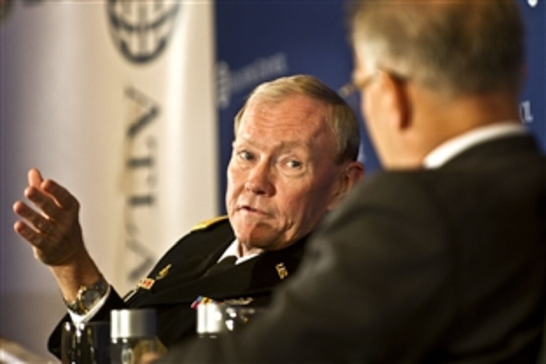 Washington Post Columnist David Ignatius moderates a public discussion with Chairman of the Joint Chiefs of Staff Gen. Martin E. Dempsey during an Atlantic Council meeting in Washington, D.C, Dec. 9, 2011.  The council promotes constructive U.S. leadership in international affairs based on the central role of the Atlantic community in meeting the challenges of the 21st century. 