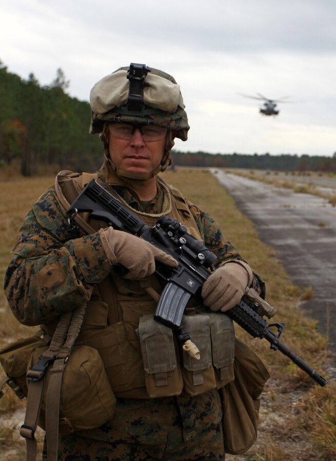 Sergeant Major Joel Collins, the Battalion Sergeant Major for Battalion Landing Team 1st Battalion, 2nd Marine Regiment, 24th Marine Expeditionary Unit, oversees Bravo Company’s security position at an airfield here as a CH-53E Super Stallion helicopter prepares to deliver humanitarian aid during a simulated humanitarian assistance operation Dec. 10, 2011. Supporting humanitarian assistance and disaster relief missions is a task that MEUs train for during their six-month work up period to prepare for deployment. The 24th MEU is currently taking part in Composite Training Unit Exercise (COMPTUEX), scheduled to take place Nov. 28 to Dec. 21. The training is meant to develop cohesion between the 24th MEU and Amphibious Squadron 8 (PHIBRON 8) in conducting amphibious operations, crisis response, and limited contingency operations while operating from the sea.
