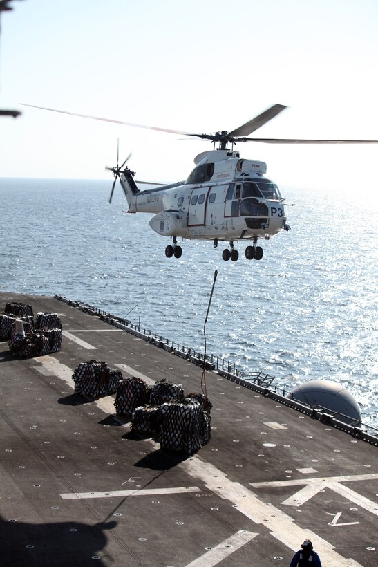 An SA-330J Puma, with U.S. Navy’s Military Sealift Command’s dry cargo ship USNS Richard E. Byrd, releases cargo on multipurpose amphibious assault ship USS Bataan (LHD5) during a replenishment at sea, Dec. 11, 2011.  The Bataan received 308 pallets of supplies and mail from USNS Richard E. Byrd.  The 22nd MEU is currently deployed as part of the Bataan Amphibious Ready Group (BATARG) as the U.S. Central Command theater reserve force, also providing support for maritime security operations and theater security cooperation efforts in the U.S. 5th Fleet area of responsibility.