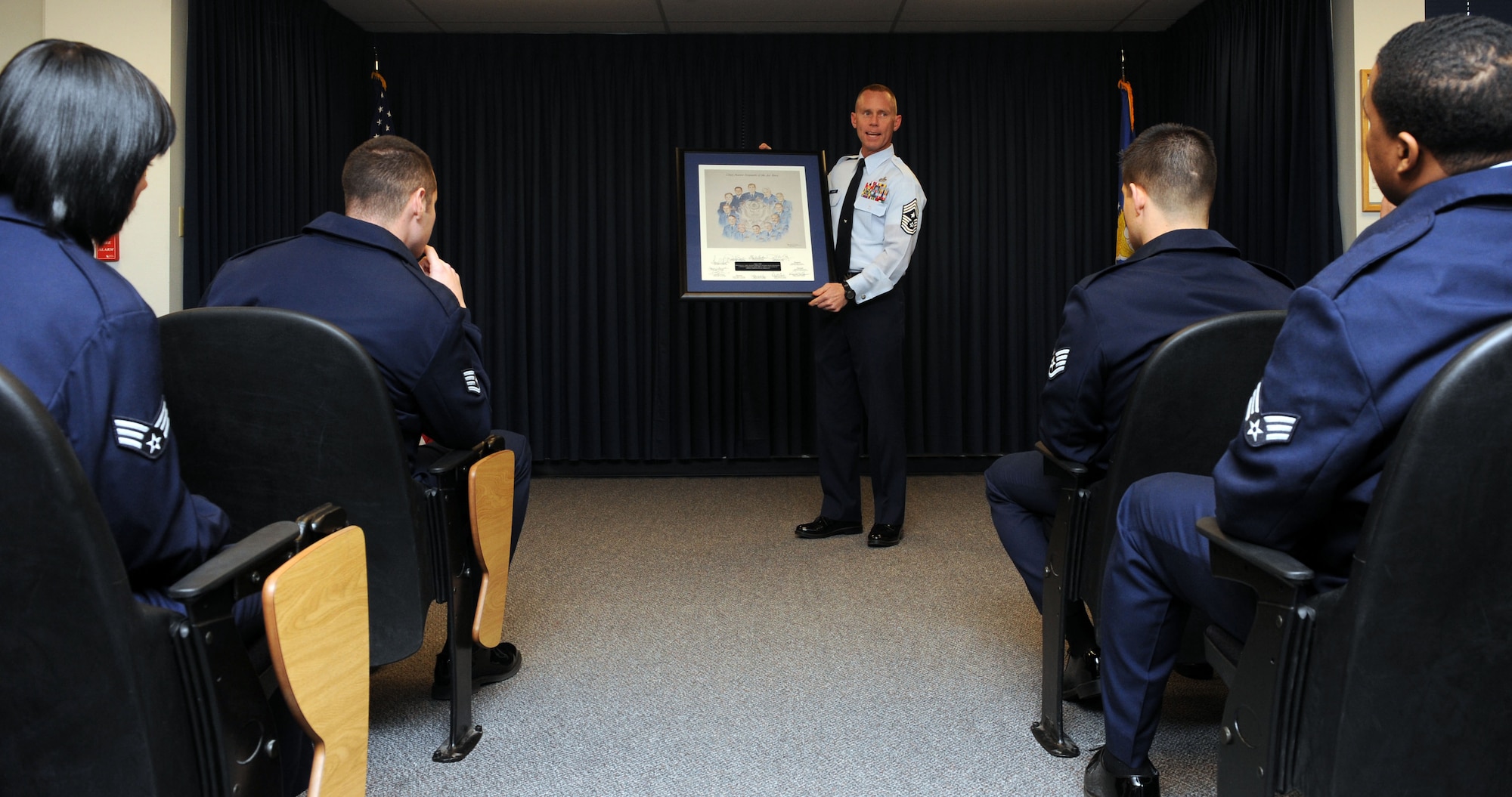 Chief Master Sgt. John Weimer, 366th Fighter Wing command chief, addresses Airman Leadership School class 12-B Dec. 12, 2011, at Mountain Home Air Force Base, Idaho.  In order to share the spirit of the enlisted heritage, retired Chief Master Sgt. Mark Reinhardt donated two lithographs depicting the surviving chief master sergeants of the Air Force as of 1986 and 1996. (U.S. Air Force photo by Senior Airman Debbie Lockhart