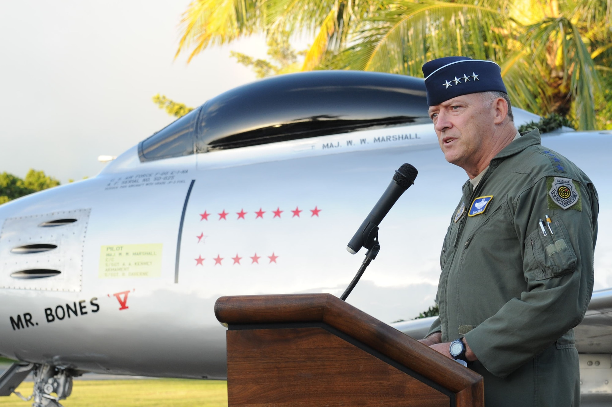 Gen. Gary North, Pacific Air Forces commander, speaks during the static F-86E Sabre fighter aircraft dedication ceremony at Joint Base Pearl Harbor-Hickam, Hawaii, Dec. 8, 2011. The Pacific Air Forces and 15th Wing leadership dedicated the aircraft to Marshall in recognition of his sacrifice and service during the Korean War. The aircraft’s stars denote the enemy aircraft destroyed, probable aircraft destroyed and aircraft damaged by Marshall. (U.S. Air Force photo/Staff Sgt. Gustavo Gonzalez/Released)