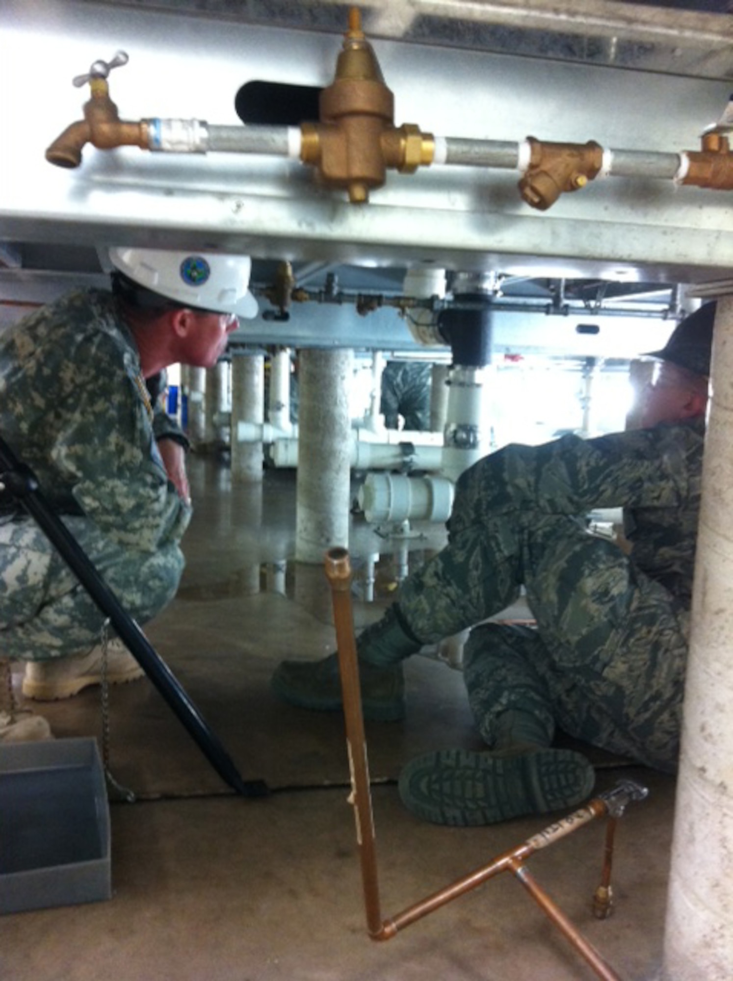 Col. Allan Webster, 1st Engineer Brigade commander (left), tours the 366th Training Squadron Water and Fuels Maintenance Schoolhouse at Sheppard Air Force Base, Texas, Dec. 6, 2011. Webster and Command Sgt. Maj. William Calhoun, 1st EN BDE command sergeant major, spent the day observing training and talking to the soldiers in training.