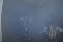 JBSA-Randolph fire fighters, 902nd Civil Engineer Squadron, run into a smoky building during a structural fire exercise on base Dec. 7. (U.S. Air Force photo/Don Lindsay)
