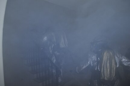 JBSA-Randolph fire fighters, 902nd Civil Engineer Squadron, run into a smoky building during a structural fire exercise on base Dec. 7. (U.S. Air Force photo/Don Lindsay)
