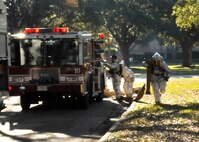 JBSA-Randolph fire fighters, 902nd Civil Engineer Squadron, run to extinguish a simulated fire during a structural fire exercise on base Dec. 7. (U.S. Air Force photo/Dona Fair)
