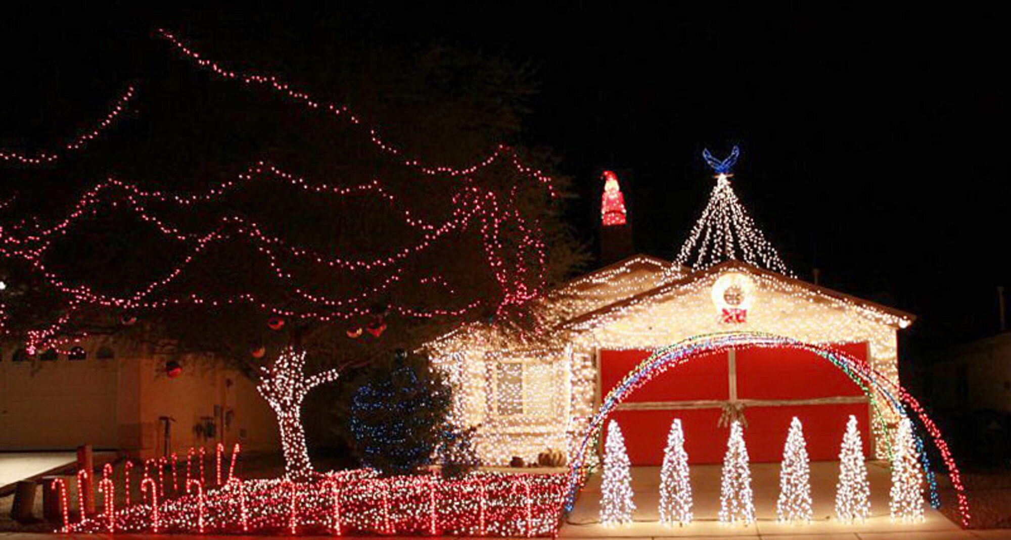 The home of U.S. Air Force 1st Lt. Joshua Palochak, 41st Electronic Combat Squadron electronic warfare officer, is covered in about 40,000 incandescent lights. The Palochaks put on a Christmas Light Show every holiday season. They also use the show to collect new, unwrapped donations for Toys for Tots. (Courtesy Photo/Released)   