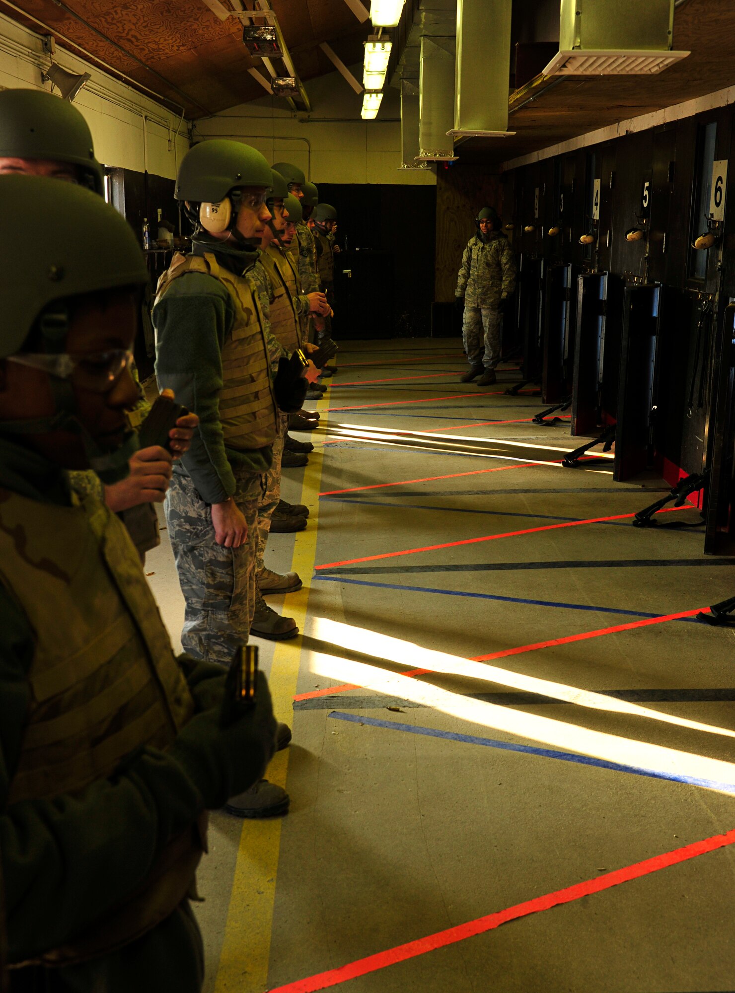 MINOT AIR FORCE BASE, N.D. -- Personnel from various squadrons train to qualify at Combat Arms Training and Maintenance here Dec. 8. CATM instructors are security forces personnel who take charge during these training sessions to ensure military members qualify on weapon use. (U.S. Air Force photo/Senior Airman Desiree Esposito)