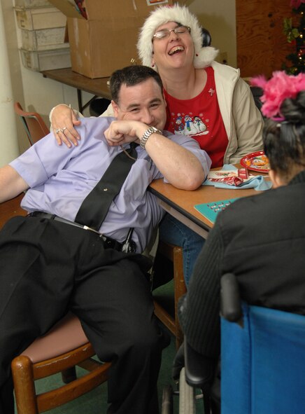 Bill Motley and Stephanie Johnson, Handicap Are Producers clients, celebrate at the annual HAP House Christmas party on Barksdale Air Force Base, La., Dec. 9. Motley and Johnson are both employed at the Hap House where they refurbish old clothes hangers to recycle for re-sell. (U.S. Air Force photo/Airman 1st Class Andrew Moua)(RELEASED)
