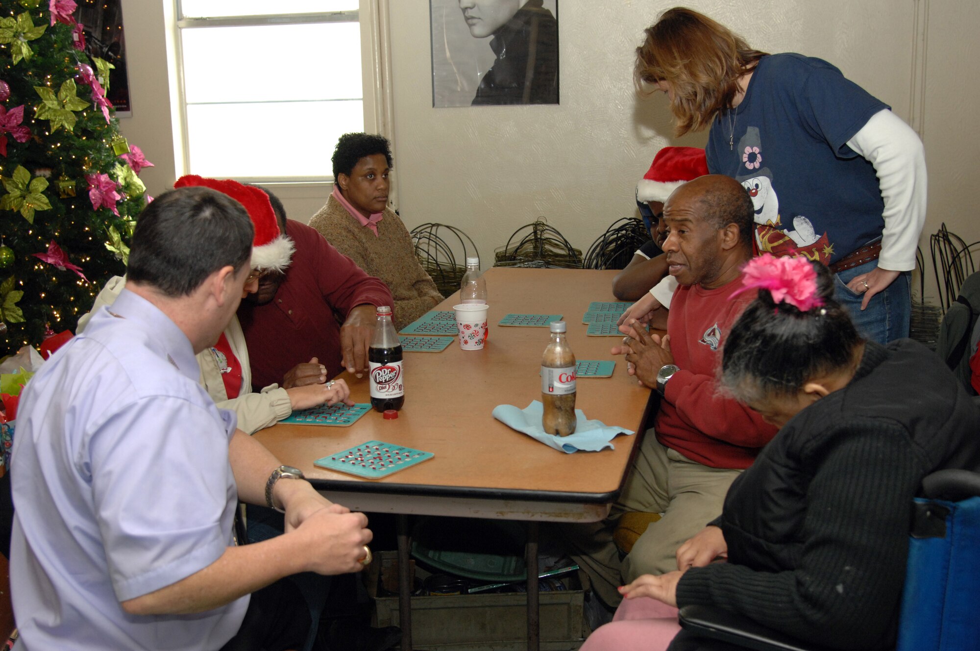 Handicap Are Producers clients play a game of bingo during the HAP House Christmas party on Barksdale Air Force Base, La., Dec. 9. The day consisted of a lunch provided by volunteers and HAP House staff, bingo with 2nd Bomb Wing Commander Col. Tim Fay and a visit from Santa Claus. (U.S. Air Force photo/Airman 1st Class Andrew Moua)(RELEASED)